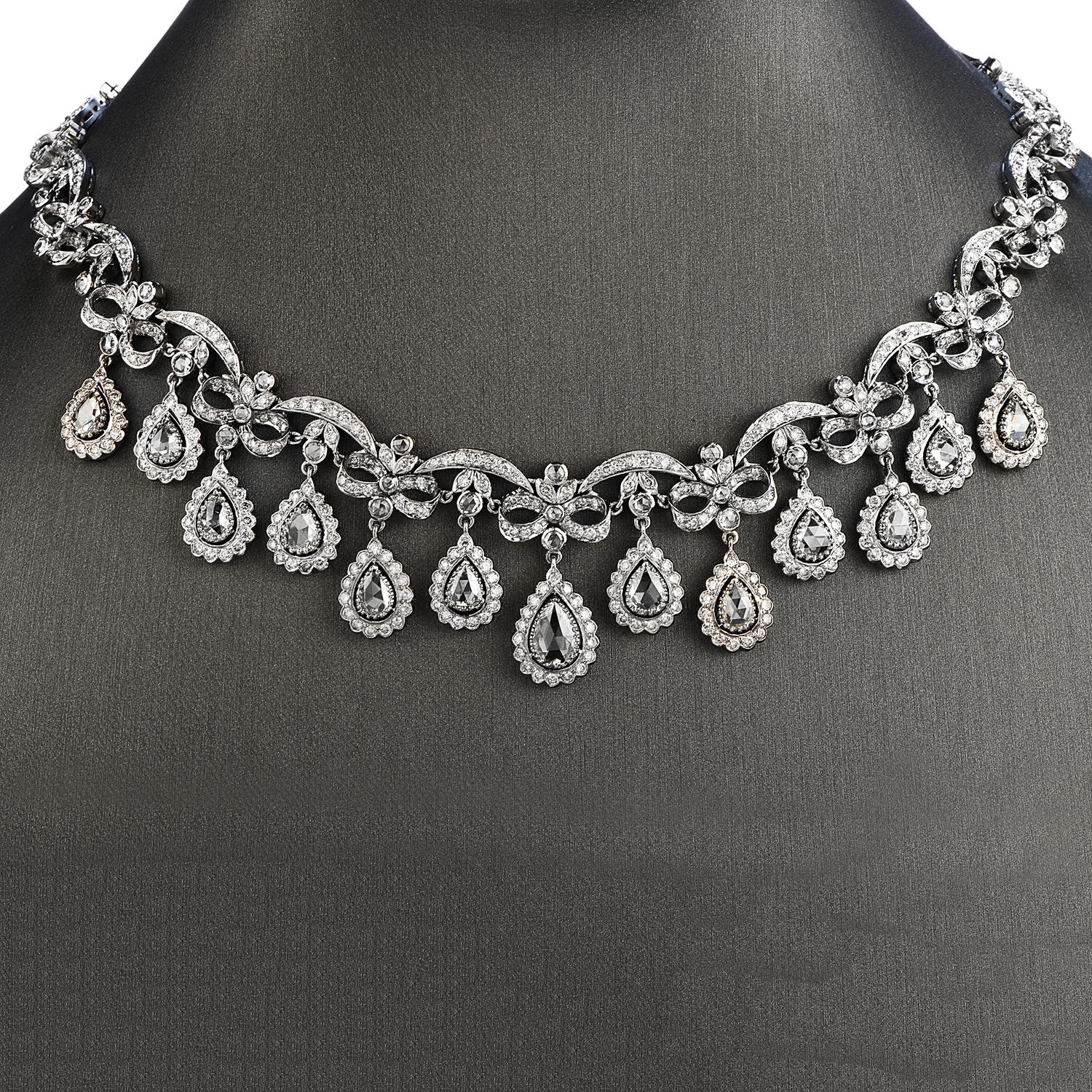 Exquisite Diamond Drop Bow Necklace with Oustanding craftsmanship in this 18k white gold. This necklace which showcases 13 Pear-Shaped Rose Cut Diamonds, weighing 6.80 carats, I-J color & VS, SI Clarity.

  Additionally, there are 160 Round