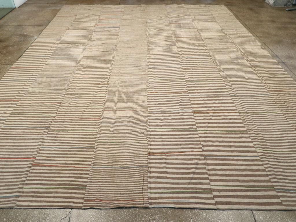 A rustic Turkish flatwoven Kilim oversized carpet handmade during the 21st century.

Measures: 13' 11