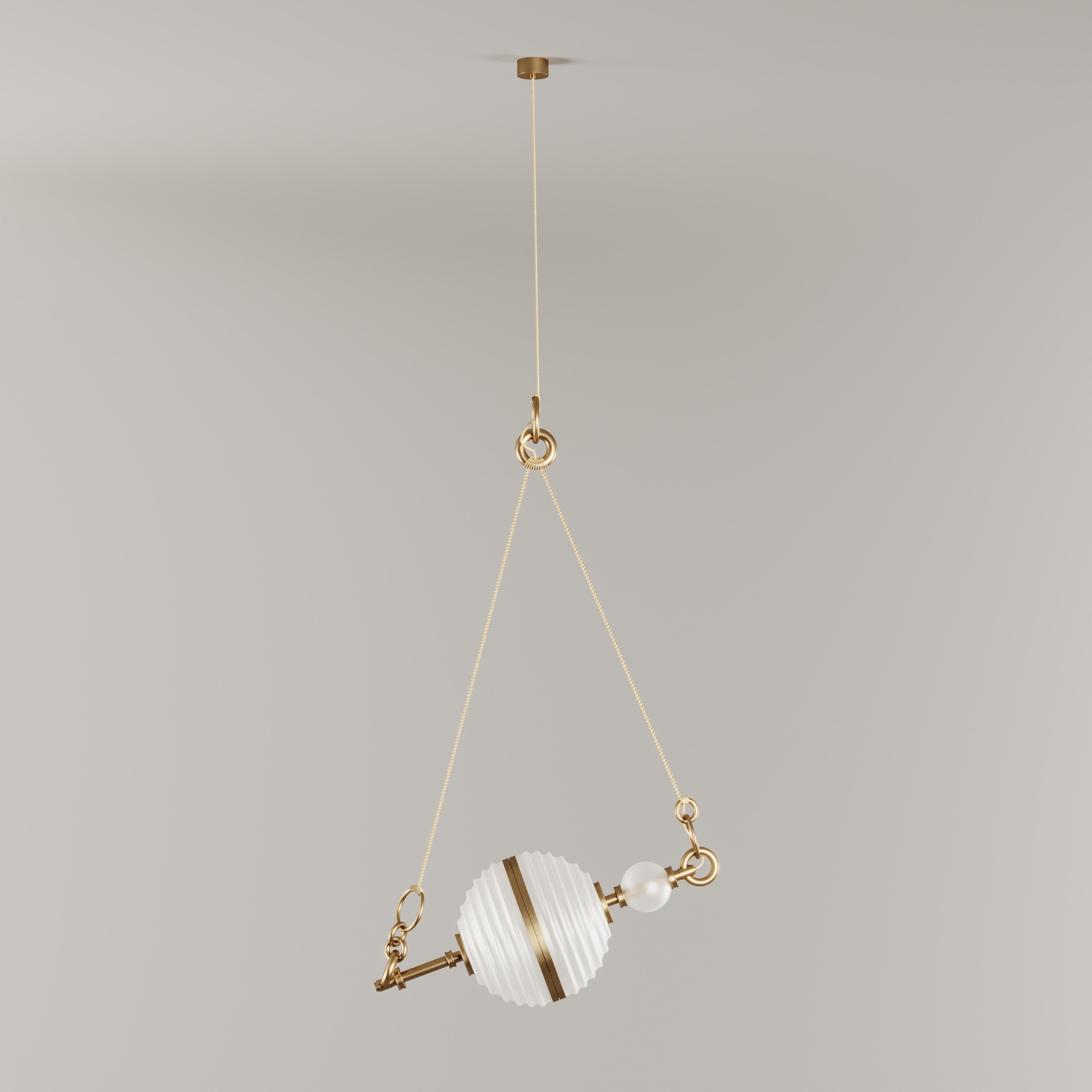 The sixth planet from the sun and the second-largest in the Solar System, Saturn was the inspiration behind this aesthetic suspension lamp design. 
Composed of one white frosted glass lampshade embellished with brushed brass around its shape that