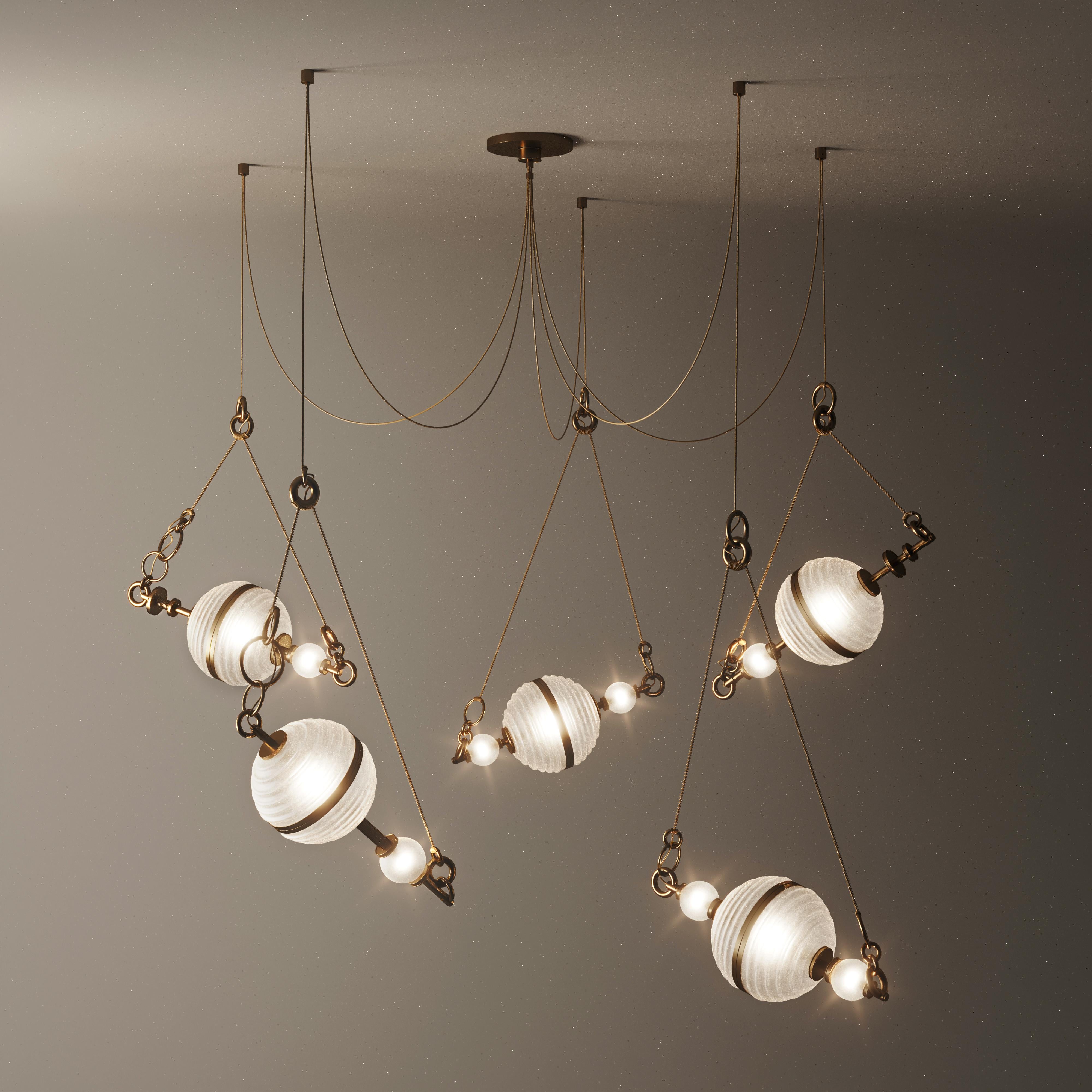 The sixth planet from the sun and the second-largest in the Solar System, Saturn was the inspiration behind this aesthetic suspension lamp design. 
Composed of five white frosted glass lampshades embellished with brushed brass around its shape that
