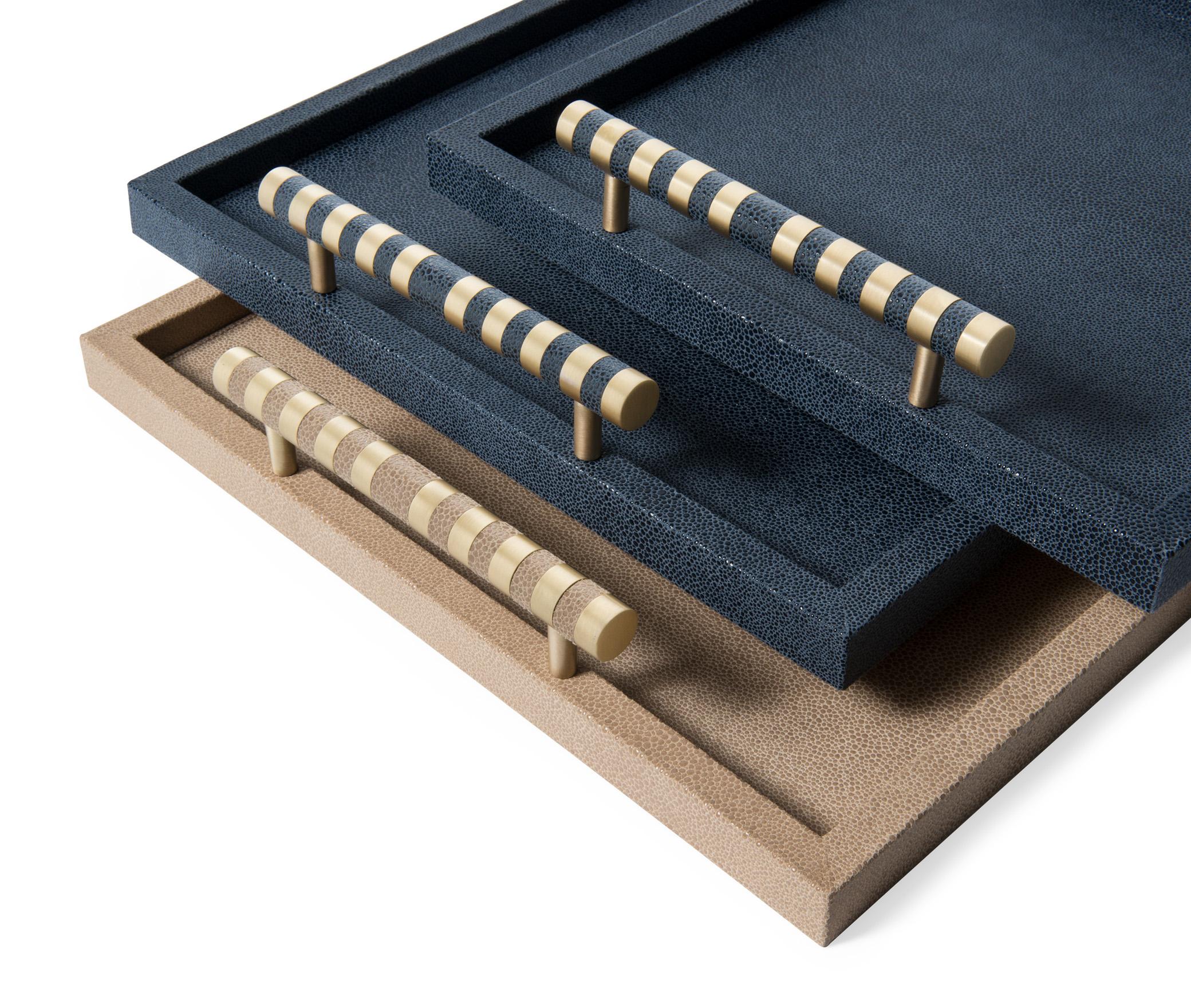 Luxury, refinement, and beauty.

Saturno collection is a set of trays crafted with a luxurious shagreen embossed effect, beautiful finished by satin brass or chrome handles with matching leather accents. The perfect addition to any décor scheme.
 