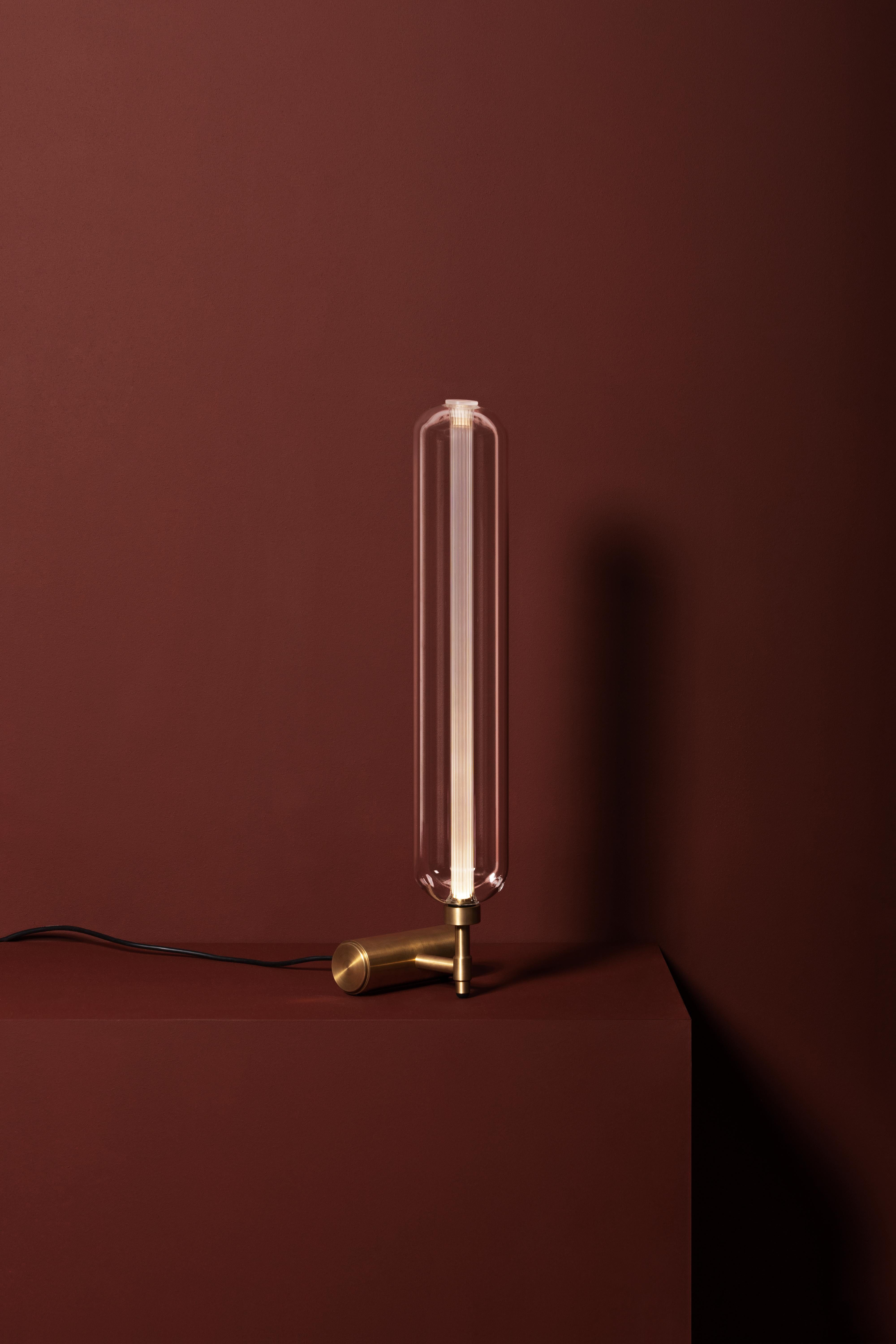 Designed by Milanese architect Pietro Russo for Dante, the Scintilla table lamp is nothing short of a solid, modern, pure and versatile lighting sculpture. The lamp is named for its sparkle effect when lit. Formed from two mouth-blown glass