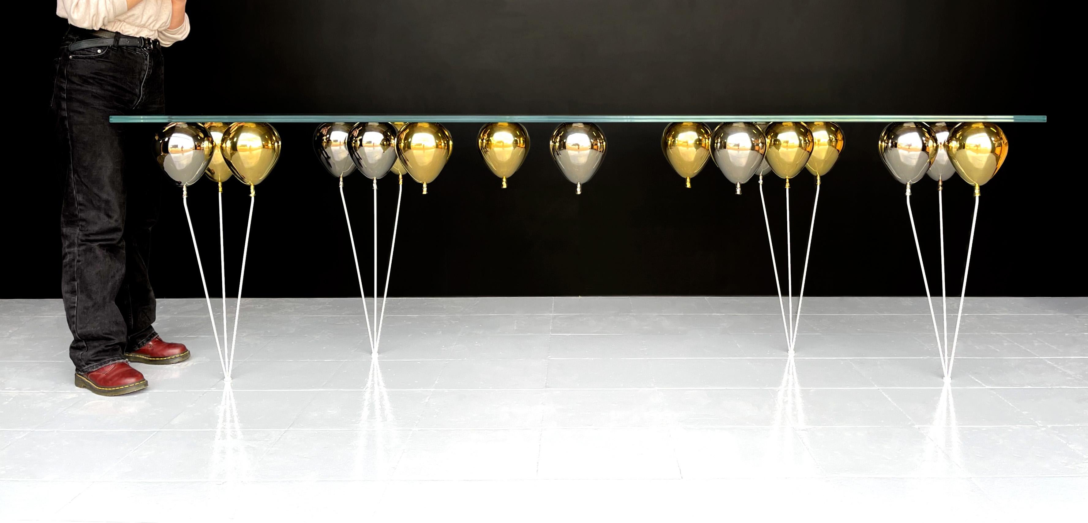 Occupying the liminal space between art and functional furniture design.

The UP Balloon console table is a playful trompe l’oeil furniture piece. A series of shimmering, polished metal balloons combine together to impress the illusion of a
