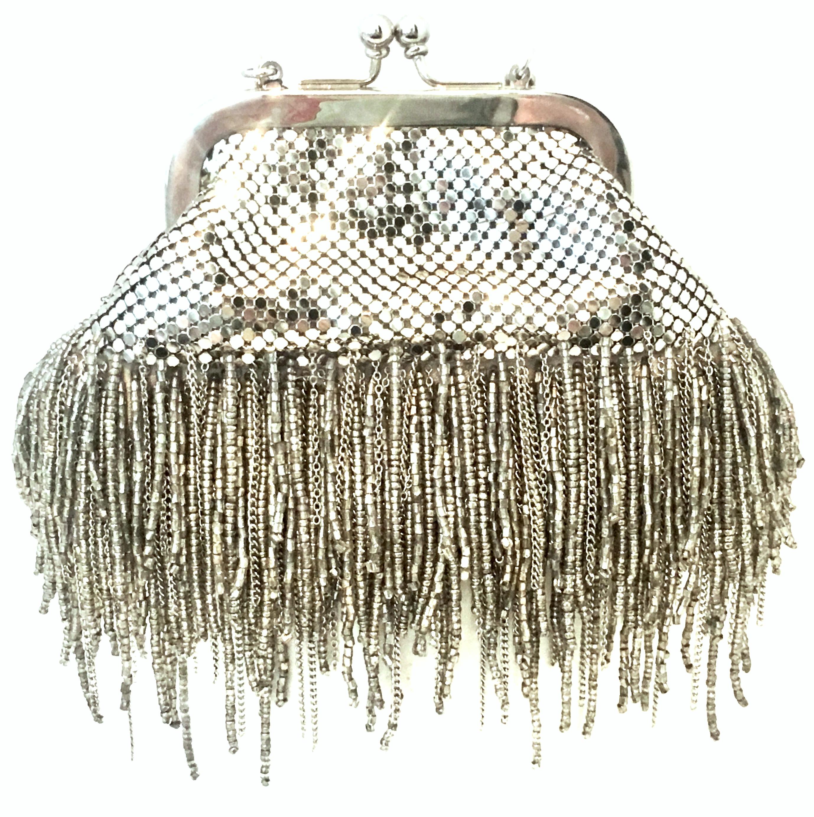 21st Century Silver Metal Mesh & Beaded Fringe Evening Bag By, Whiting & Davis. This new silver plate metal mesh with cut steel beaded fringe evening bag maintains the original manufacture tag. This soft side multi purpose piece features the iconic