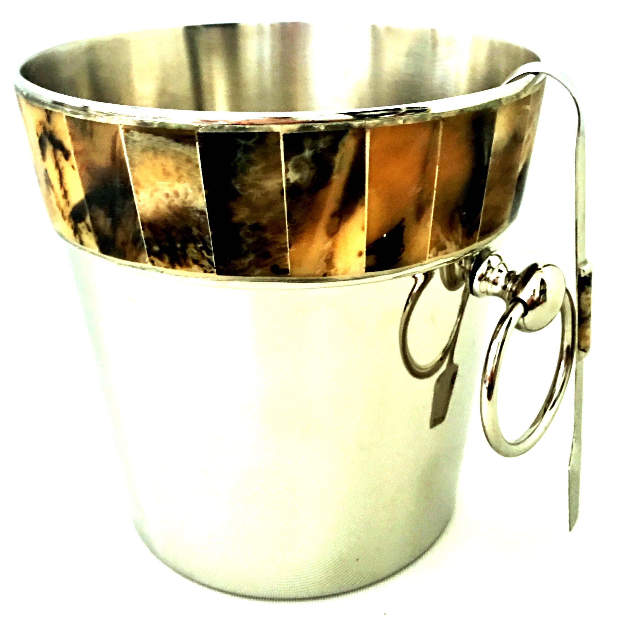 21st century silver plate and horn inlay champagne/ice bucket and tongs set of two pieces. The bucket features round silver ring handles and is marked on the underside with silver plate hallmarks. The tongs measure, 7