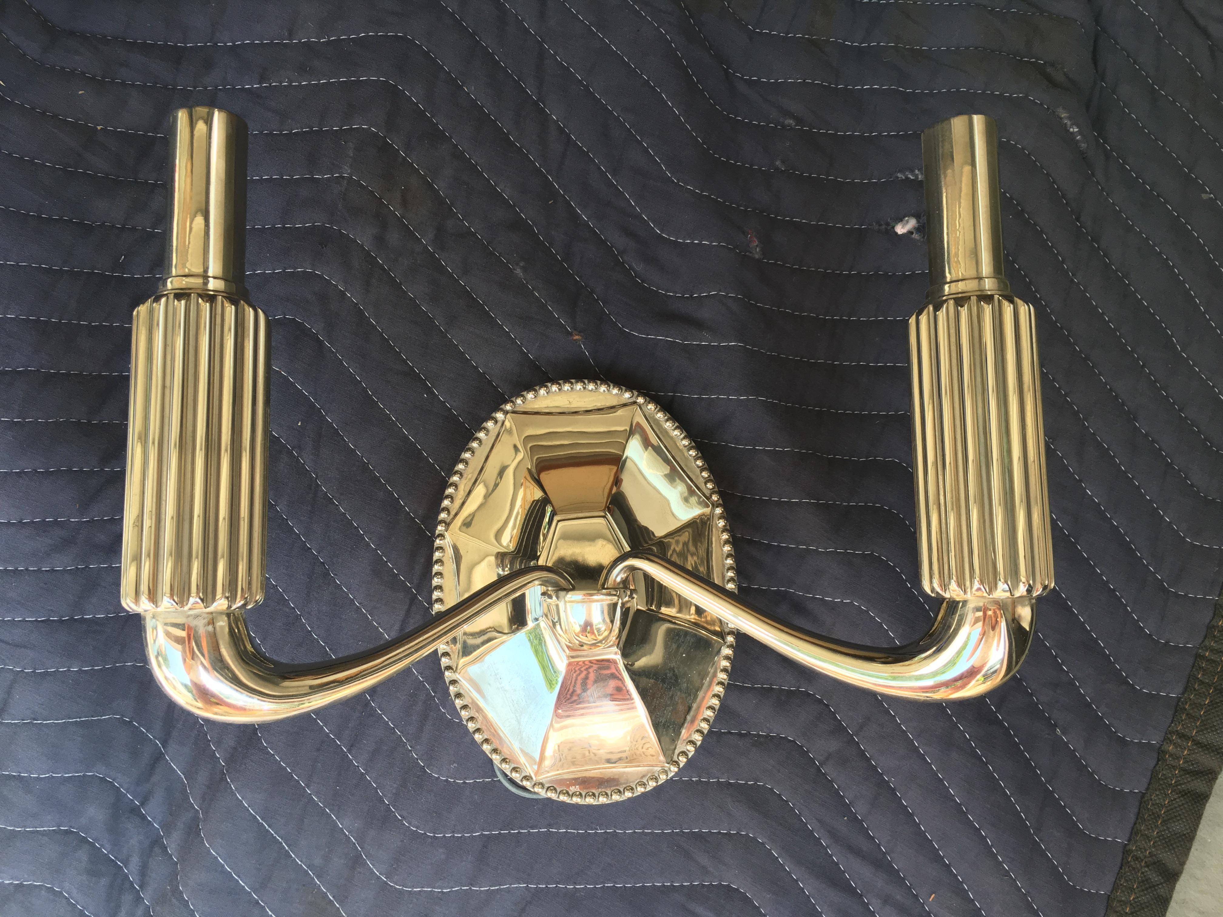 21st century single 'Paris Two Arm' sconce in polished nickel by Urban Archaeology.

This is handcrafted by Urban Archaeology designers and artisans in a beautiful Art Deco style design. 

This is a single two-arm sconce without shades.

Measures: