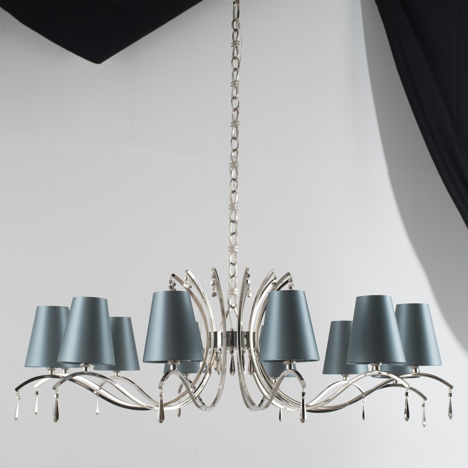 A series of metallic bending ramifications that unravel in space, starting from a branching point. A vibrating structure that sustains a carousel of delicate lampshades. A lamp which joins a retro style with the allfeminine habit of tout-court