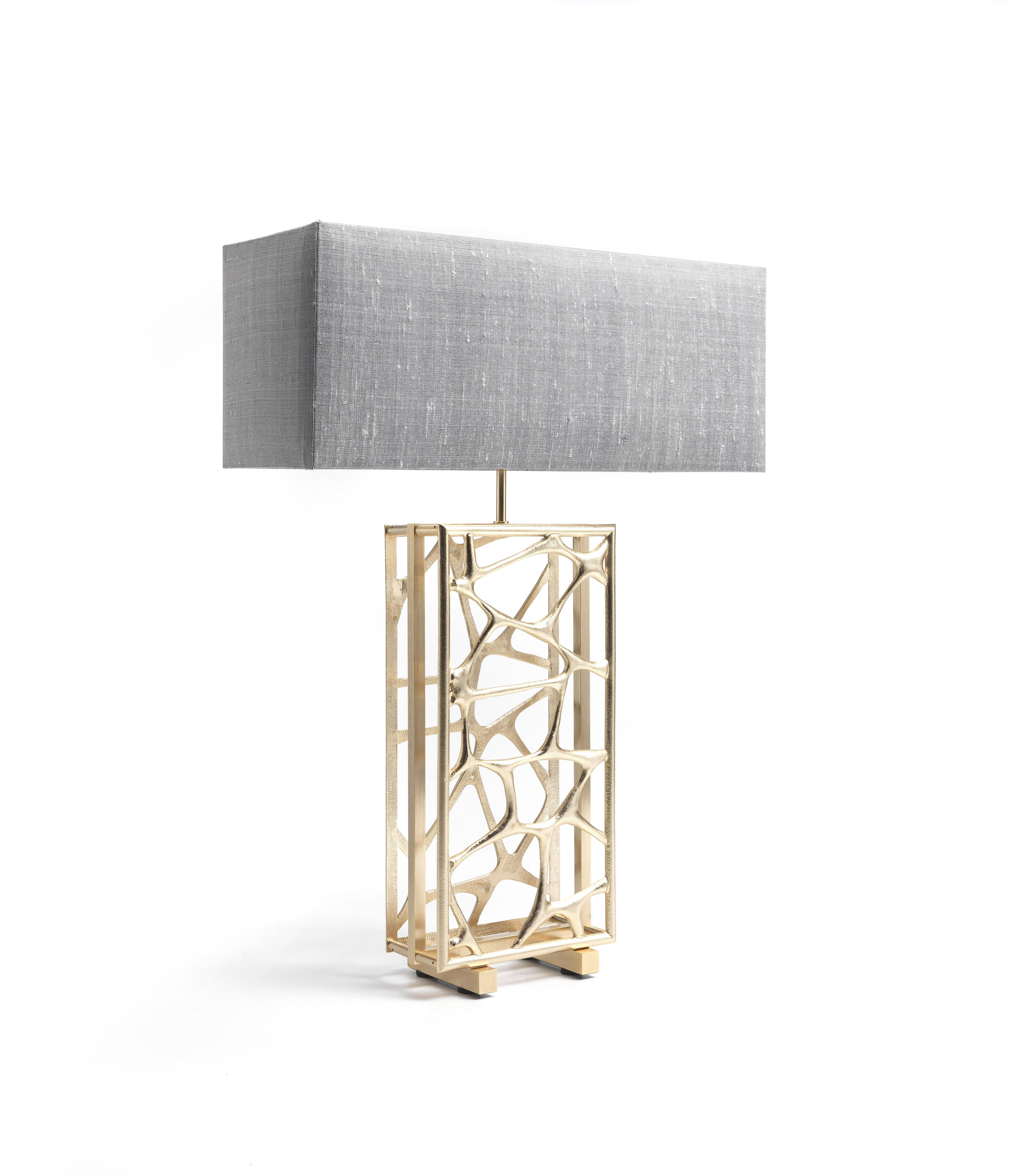Sioraf.4 Table lamp with brass structure in gold finishing. Shade in shantung silk col. silver.
 