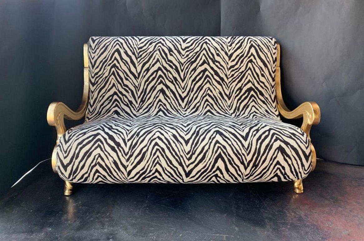 21st century slick living room set, hand carved wood with gold gilt. Newly upholstery, this set is truly one of a kind. France, 2000.

Sofa measurements: W 60in, D 40in, H 38in.
Chair measurements: W 30in, D 37in, H 39in.