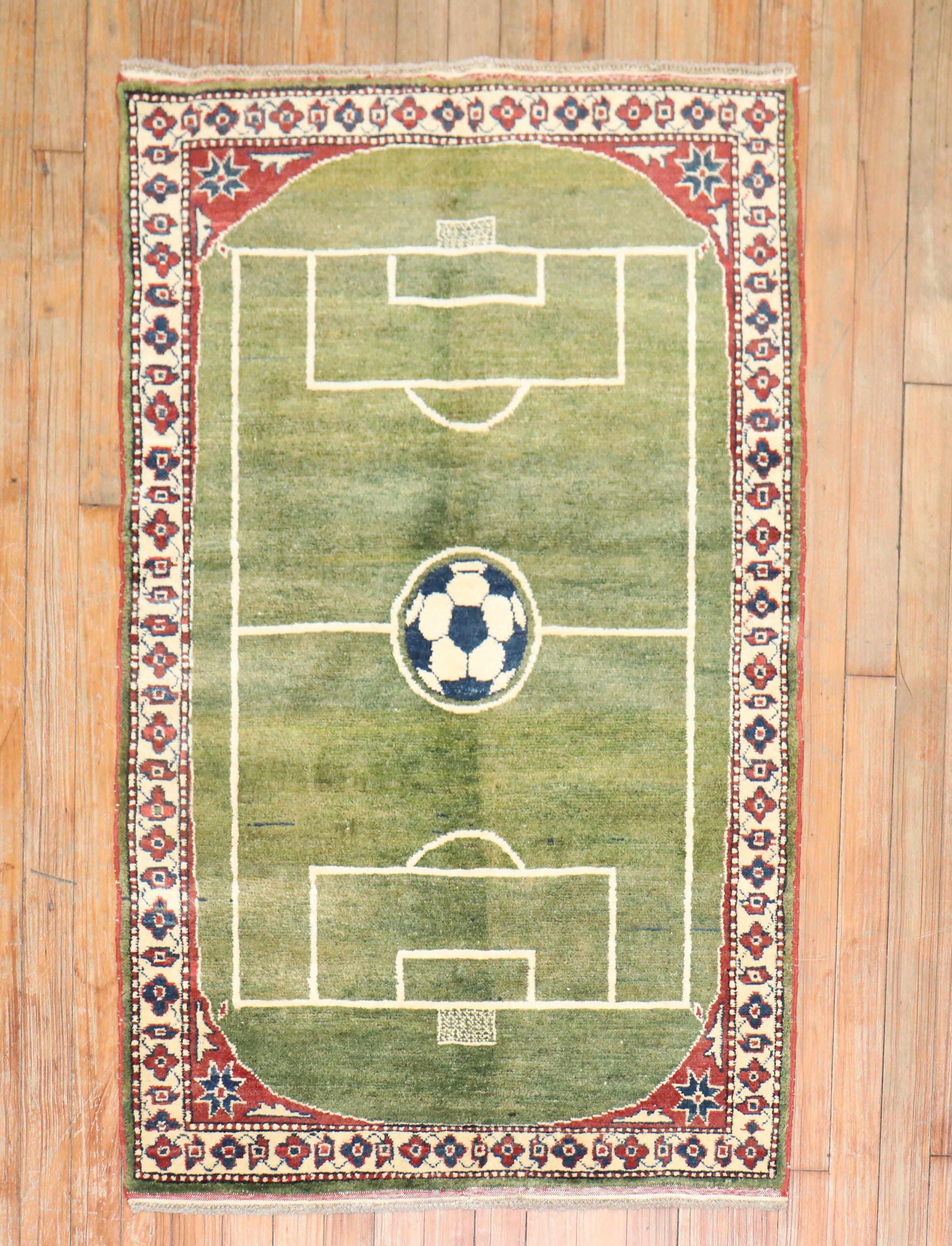 One of a kind hand-knotted 100 % vegetable-dyed rug depicting a soccer field surrounded by a traditional border.

Measures: 2'7'' x 4'.