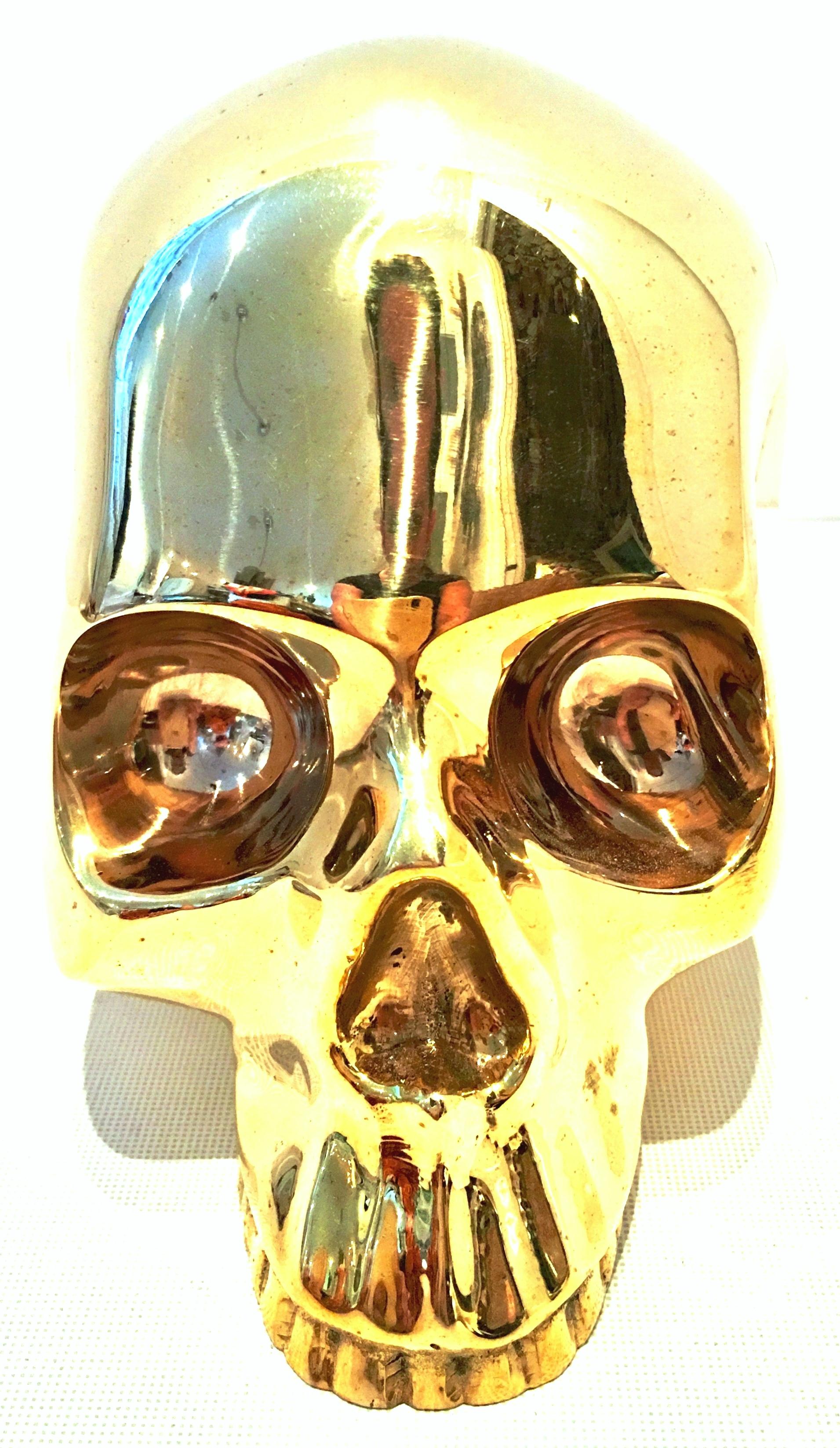 21st Century and new solid brass skull head sculpture by, D.L. & Co. This new heavy weight gilt gold, solid brass sculpture is signed on the back side, D.L. & Co. Includes the original black gift box and black protective drawstring protective