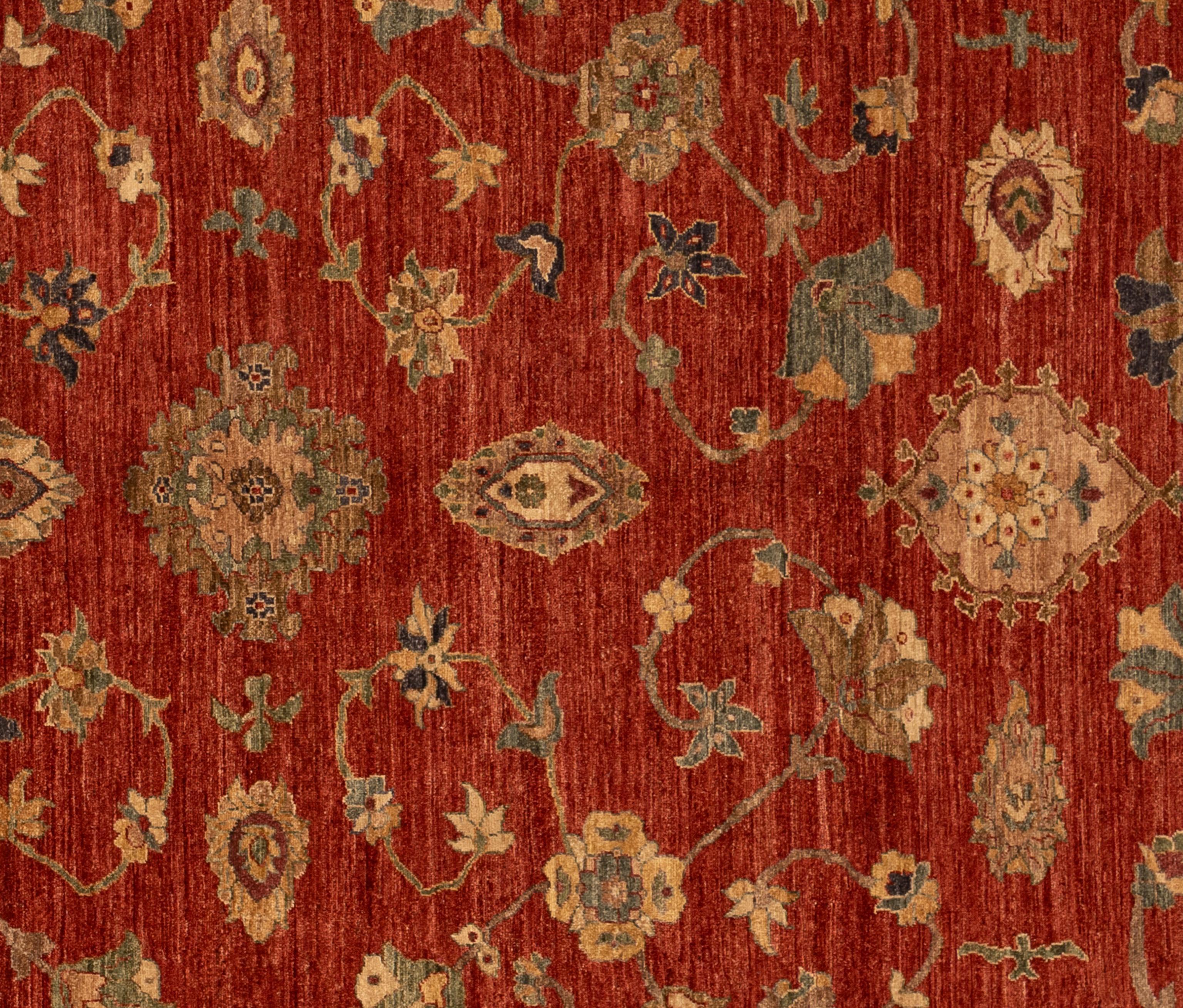 This Sultanabad rug is hand-knotted from fine wool, featuring the hallmark large-scale floral and vine motifs that flow gracefully across its open field. The spacious design is framed by a well-balanced border, creating a harmonious sense of