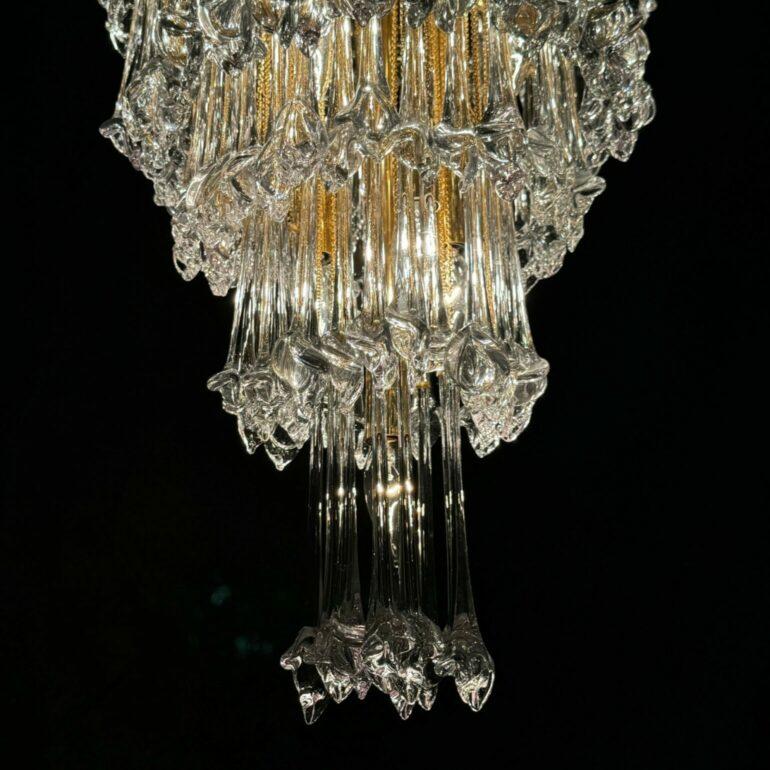 This rare Italian chandelier is an exquisite piece that exemplifies opulence, intricate craftsmanship, and timeless elegance, harkening back to an era of glamorous decor and unmatched artistry. It boasts nearly 200 individual ornaments, each