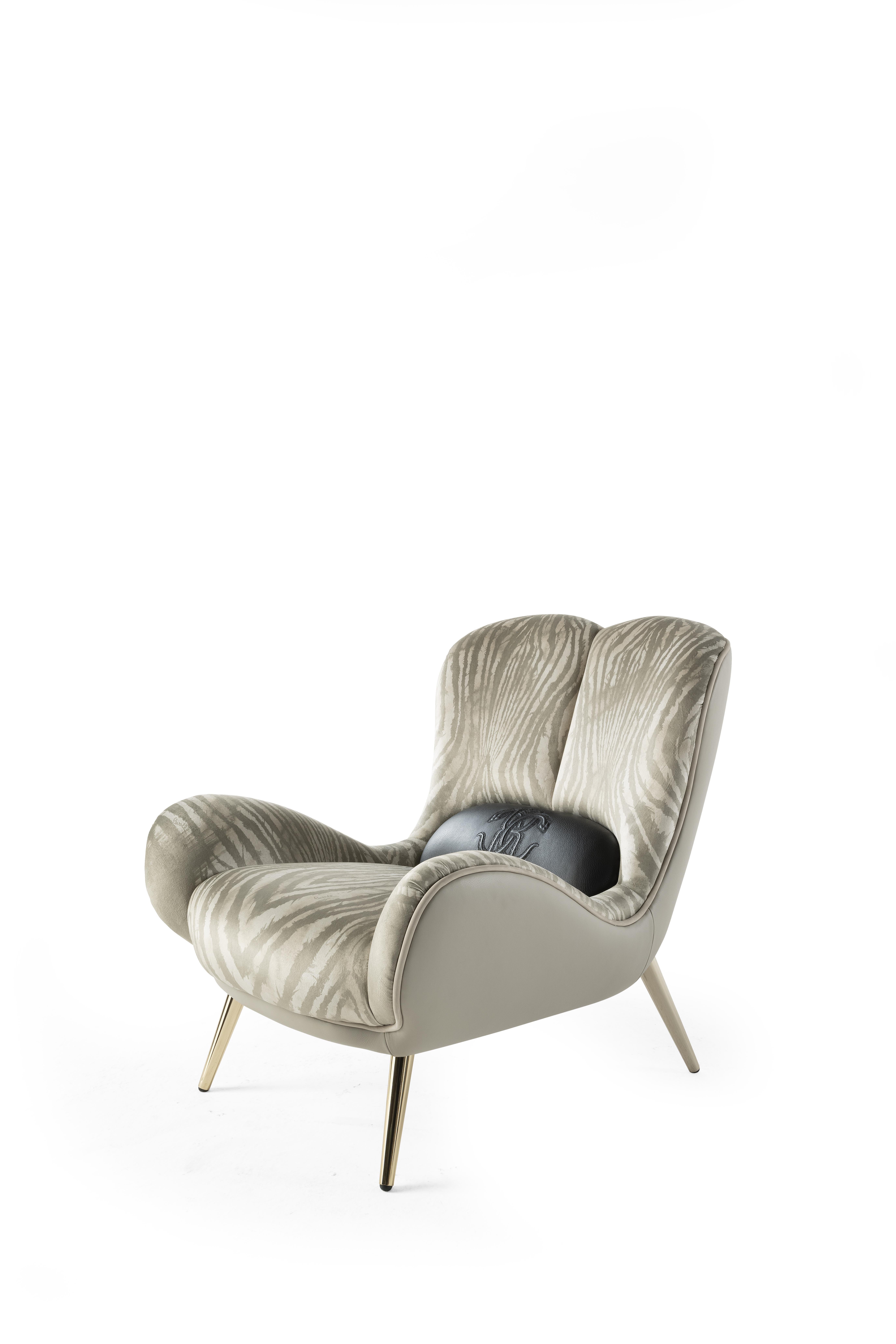 Soft shapes and exotic suggestions for the Tifnit armchair. The upholstery with the new Wild Zebra pattern evokes a wild and sensual spirit. The external structure upholstered in leather lends a gritty allure to the whole, while the glossy gold feet