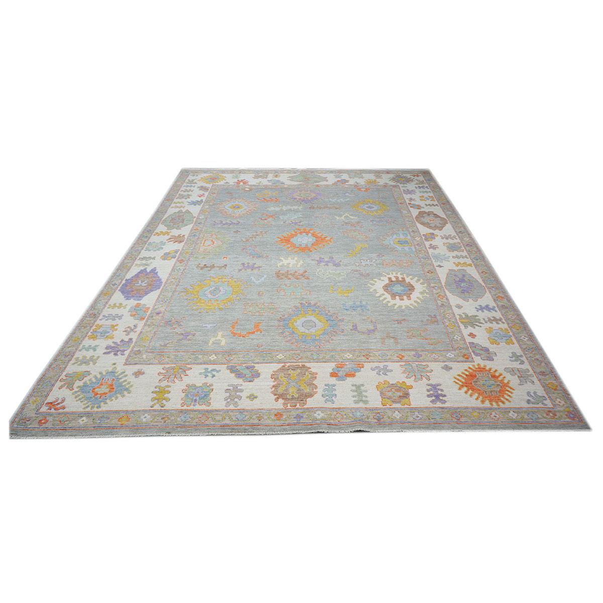 Ashly Fine Rugs presents a 21st-century Turkish Oushak 8x10 grey, ivory, & multi color handmade area rug. Oushaks began in a location just south of Istanbul, in a region that was to become the rugs namesake, Oushak. Although nomads first produced