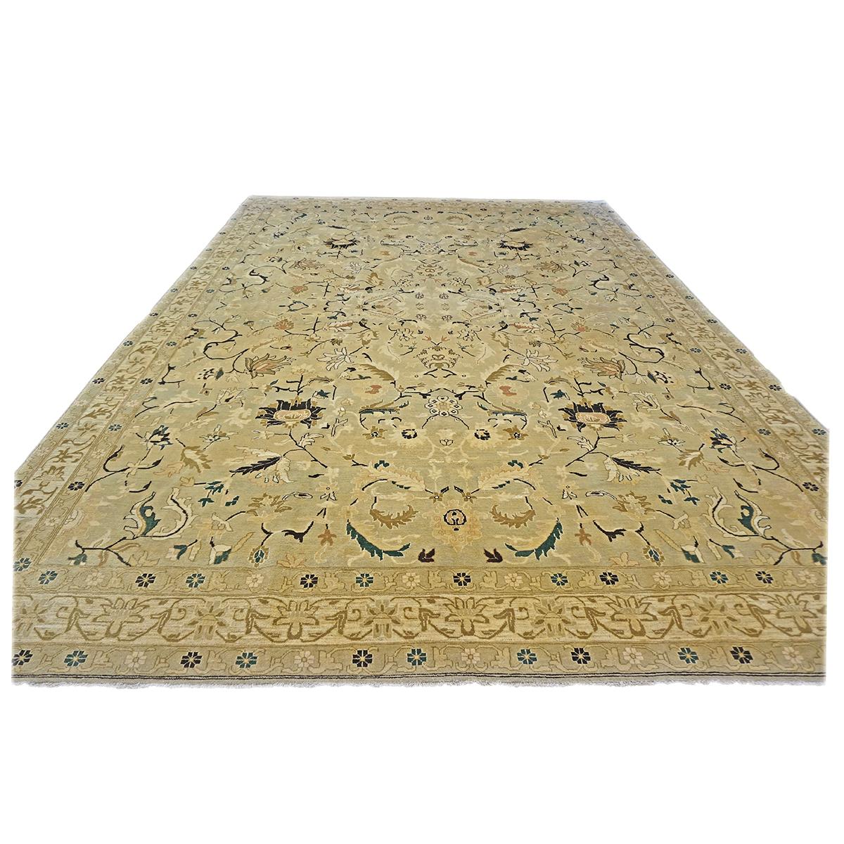 Ashly Fine Rugs presents a 21st-century Turkish Agra 9x12 Light Olive Handmade Area Rug was made with 100% hand-twisted and vegetable-dyed wool fibers. The background is a very light olive and khaki color, with the design and details consisting of a