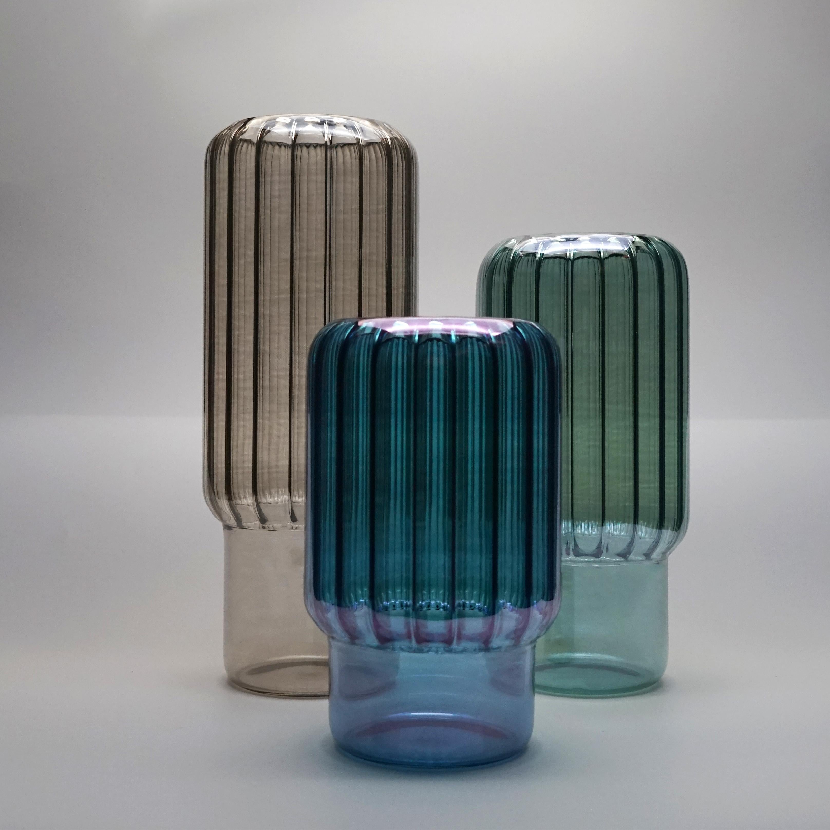 The vases set Brumma are designed to enhance any floral arrangement, perfect for a single stem or a beautiful bouquet. 
A quiet design but with a great personality suitable in any style of home.
They are handmade by Venetian artisans and the color