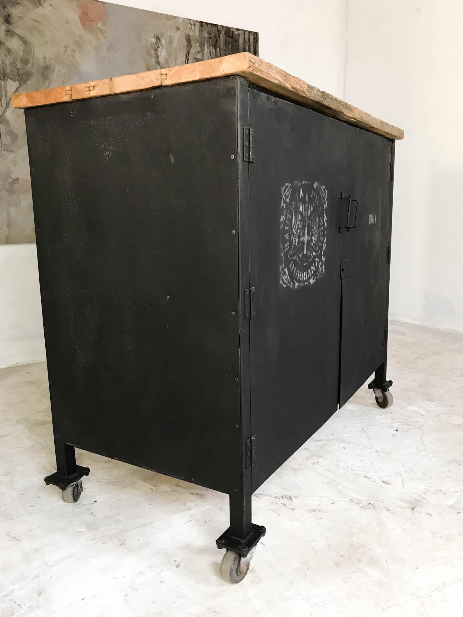 Really practical and good looking piece of vintage Industrial furniture. This two door steel cabinet has been painted black with white stencils and has a new reclaimed pine wooden top which creates the perfect contrast to the black exterior. Inside,