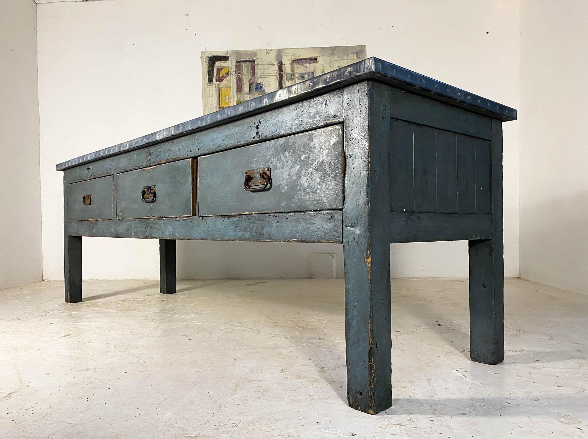 Fully restored industrial workbench which has three large drawers with original pull handles and finished with an aged zinc top. It has been later painted in a dark grey which contrasts perfectly with the zinc and is clean and ready to go!

It is