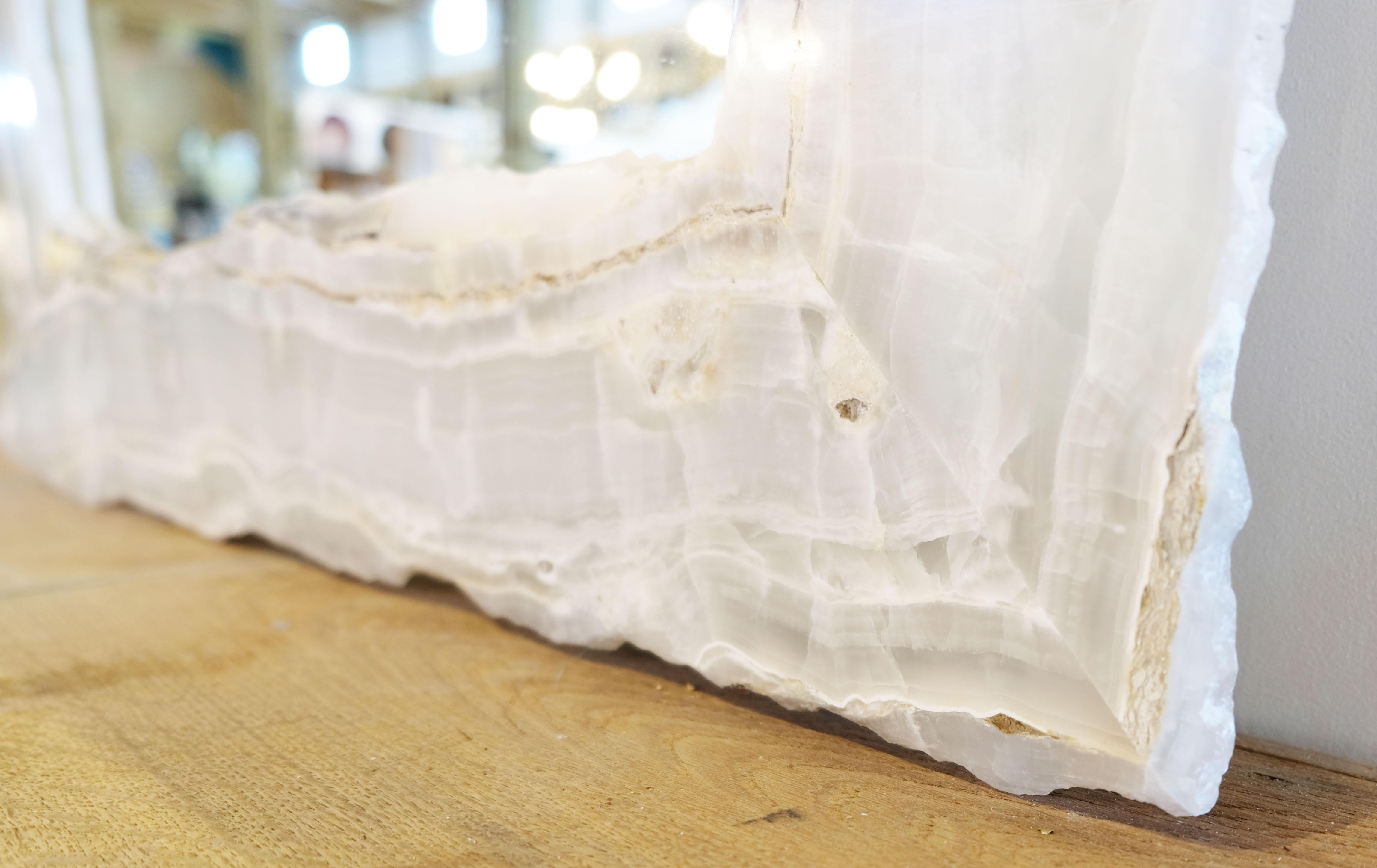 Chic white onyx wall mirror with hardware to hang vertically or horizontally.