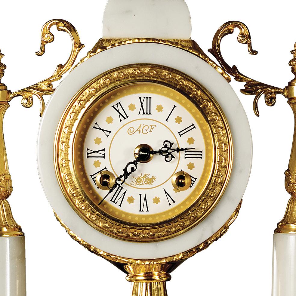 21st century white veined marble and golden bronze clock. This clock is finely chiseled lost wax castings. This clock has a mechanical 8 days wind movement and separate winding for alarm, chiming every half hour. On request to customer can