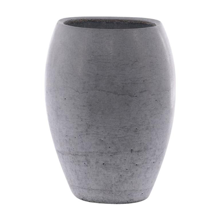 The Zazen line combines organic shapes with the texture of concrete, giving life to a family of four highly recognizable vases.
Each vase is produced from a monolithic concrete casting. The design of Zazen makes it possible to reduce thickness to a