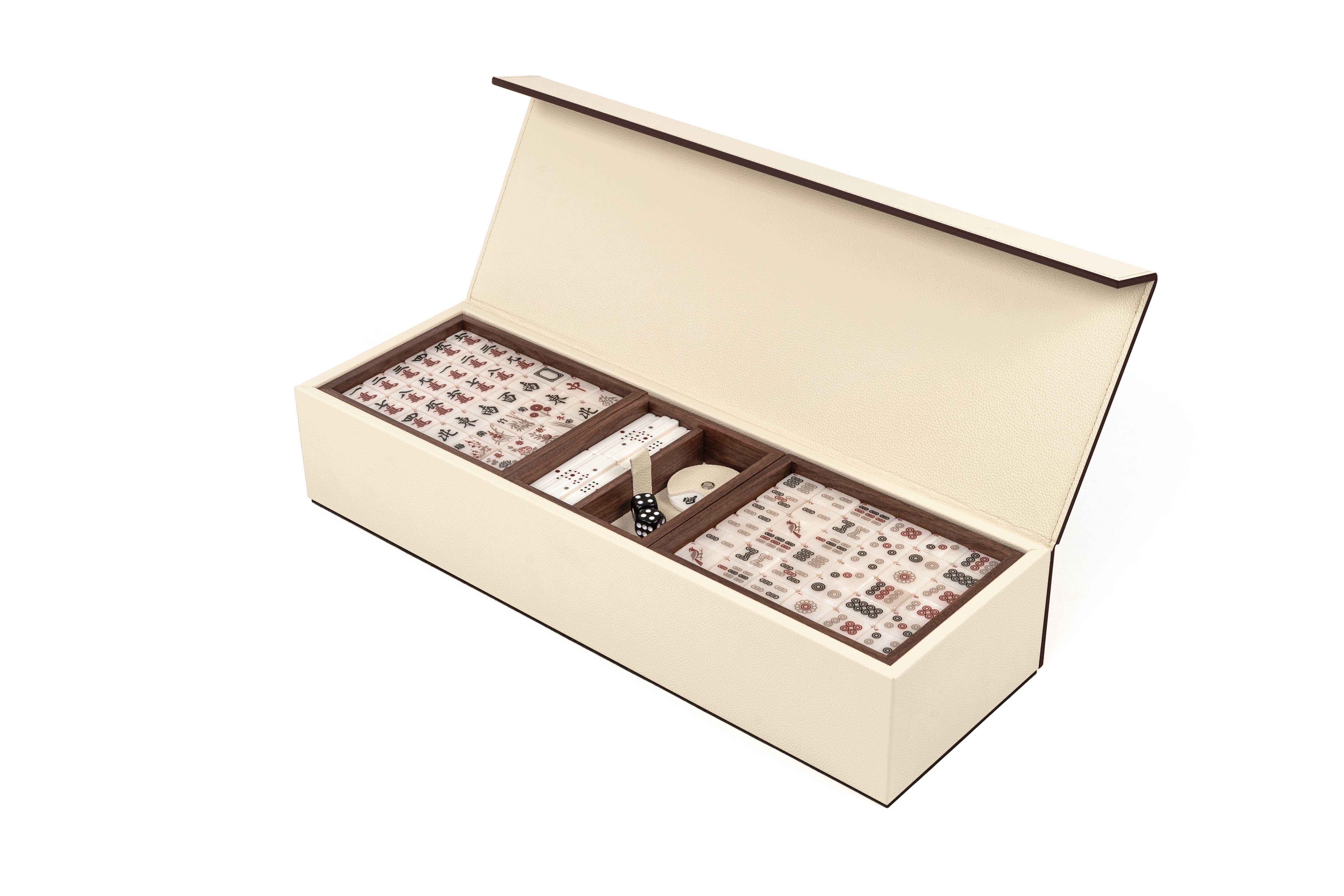 Our brand new Mahjong, a complete restyling for one of the most popular and played games worldwide. 

Entirely covered in genuine calf leather, our Mahjong comes in a luxurious wooden box with a magnetic closure lid. The set is composed by 144