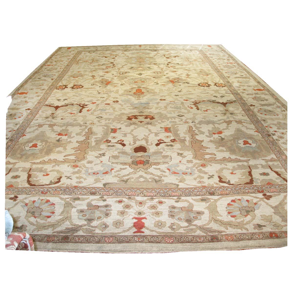 Ashly Fine Rugs presents an antique recreation of an original Persian Sultanabad 13x20 Ivory, Tan, & Blue Handmade Area Rug. Part of our own previous production, this antique recreation was thought of and created in-house and 100% handmade in Iran