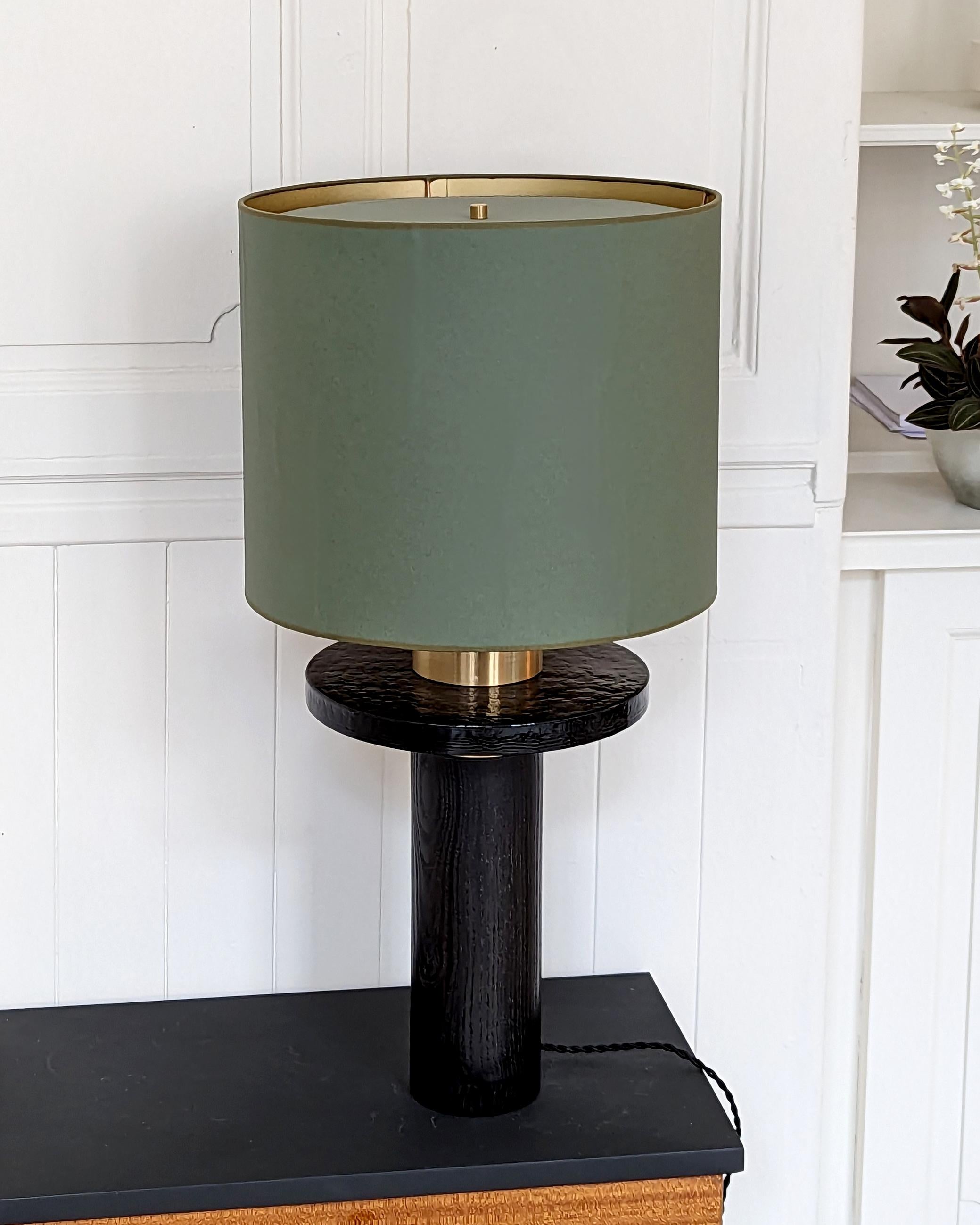 The Ines lamp combines cast glass and oxidized wood to create an indispensable and exquisite piece. Its paper lampshade delicately diffuses a soft, warm light, adding a gentle ambiance to any space it graces.
This lamp is suitable for lighting a