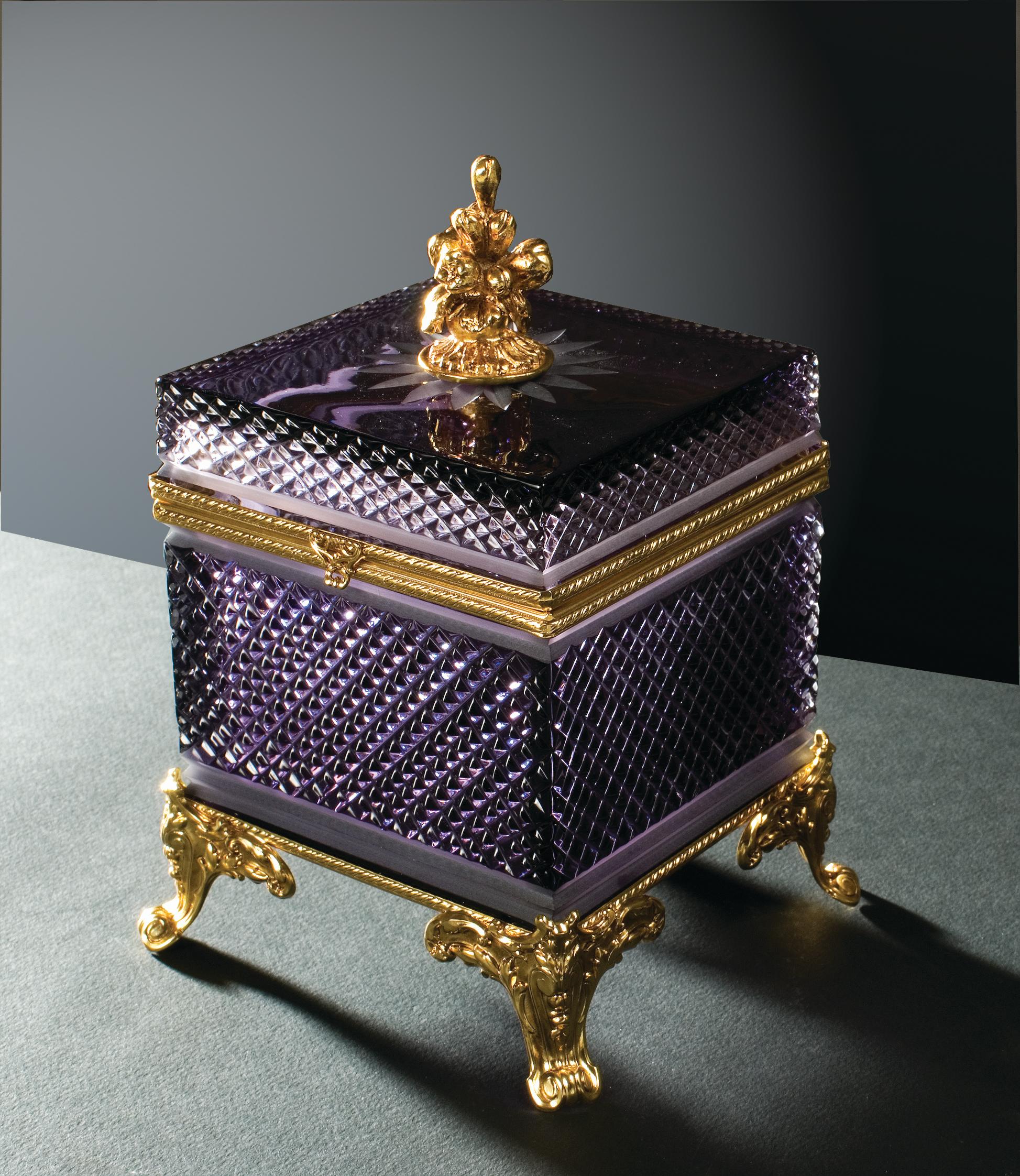 Amethyst crystal box with cut engravings embellished with brass detail made with the artisan lost wax technique with patinated gold finish. Each object is handcrafted and the care for every detail makes each item unique in its kind.
The style of