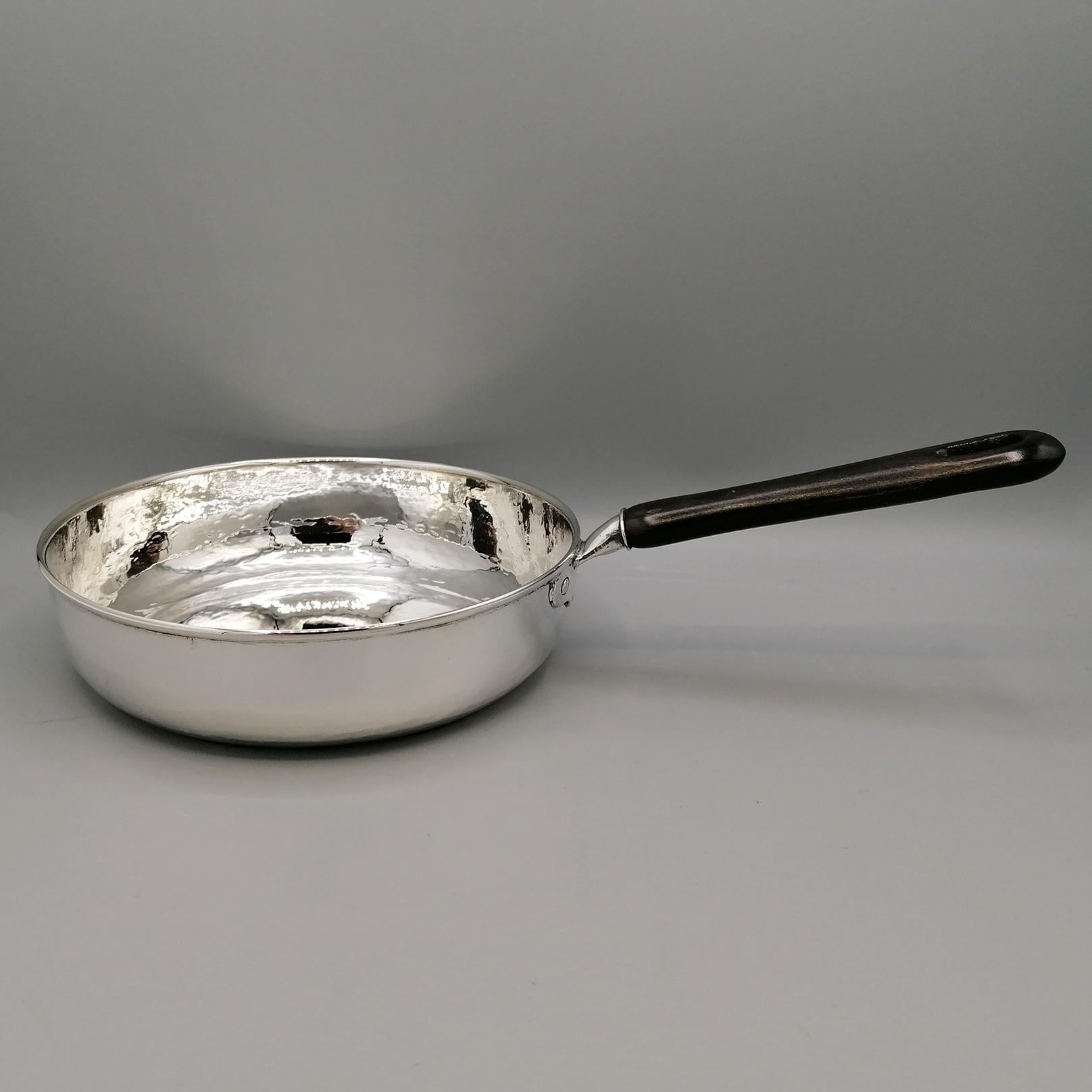 Unusual 800 silver ornament with pan-shaped wooden handle.
A flattened tube, also in silver, has been welded to the round and hammered part, where a wooden handle has been inserted
