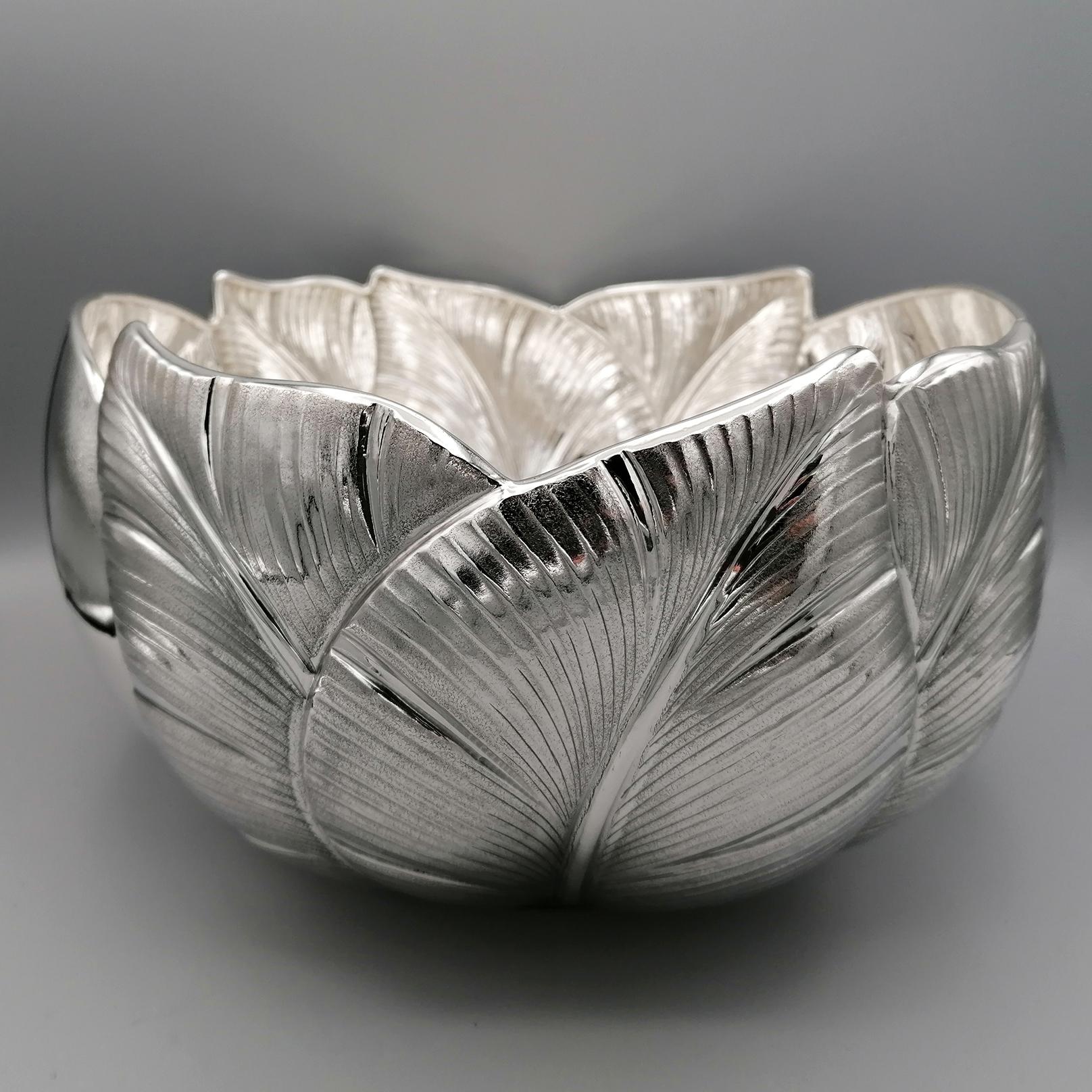 Solid sterling silver centerpiece. 
The shape of the body of the large bowl is round, rounded and shaped in the upper part to follow the design of the leaves. 
The leaf design was embossed and subsequently chiseled with a slight knurling to