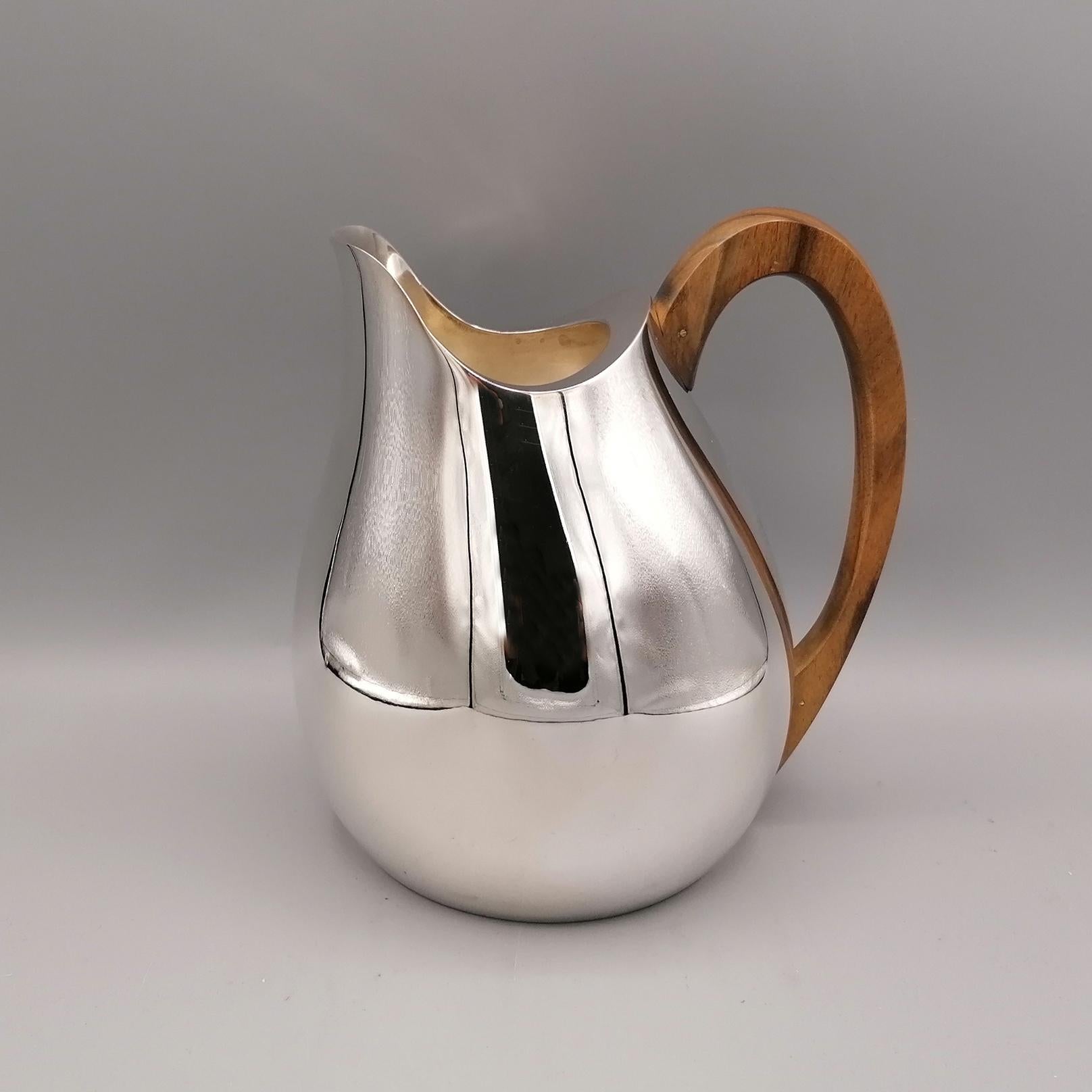 Solid sterling silver water carafe. 
It contains 1 liter of water
The body is round and has been completely handmade starting from a flat silver sheet and subsequently modeled to give the object a round and slender shape, in the shape of a ball.
The