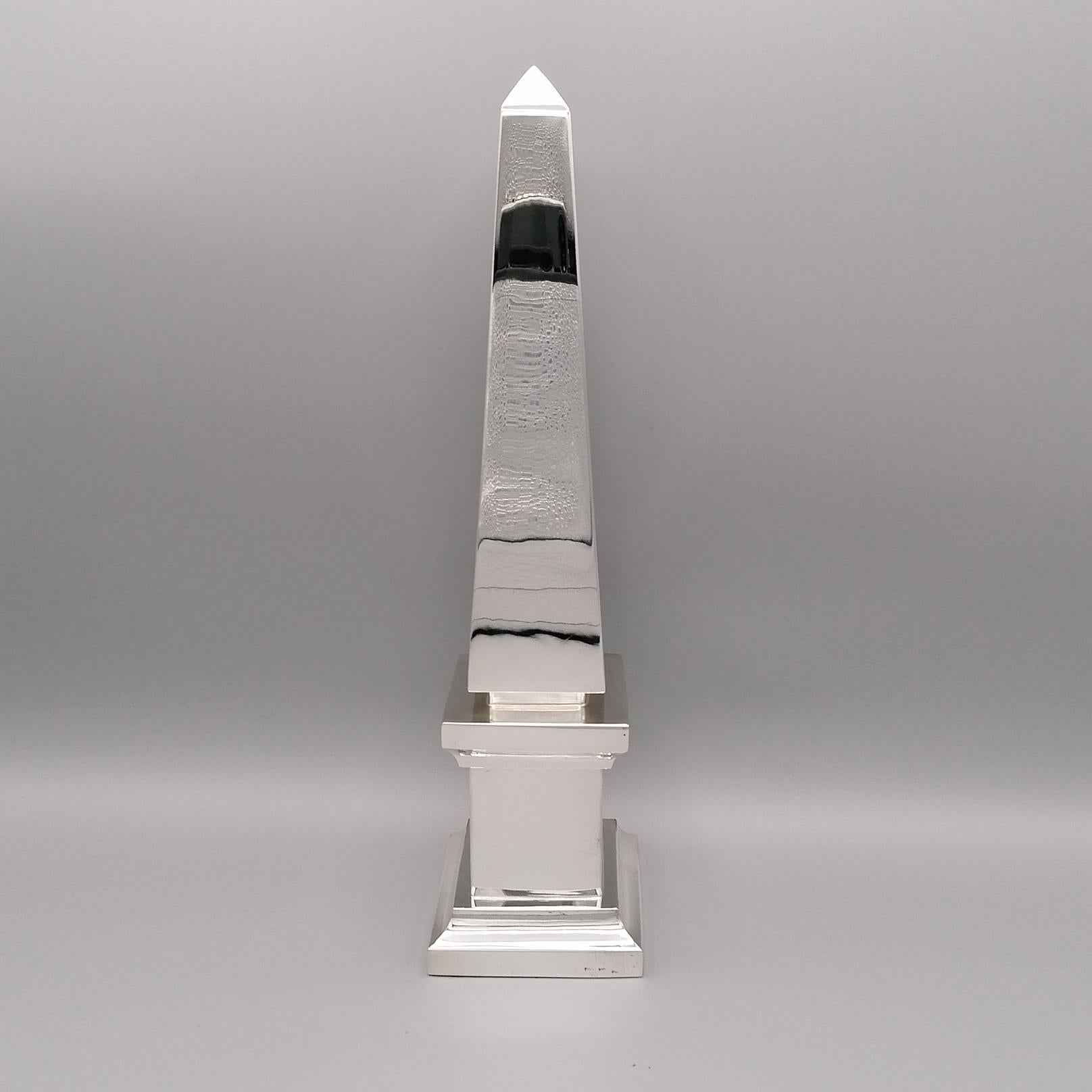 Solid sterling silver obelisk.
Made entirely by hand, the obelisk is completely smooth fixed on a square base of different sizes and sections.