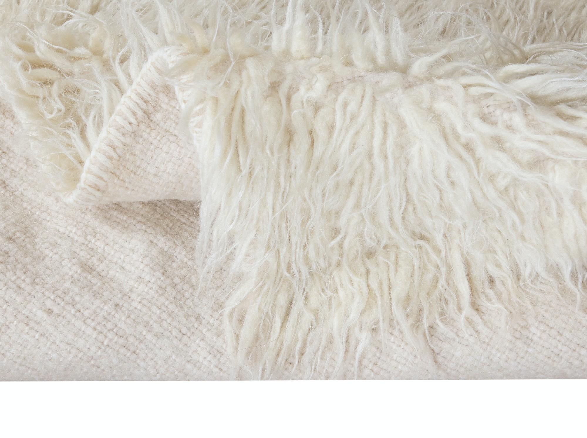 A vintage hand-knotted shag pile rug made of natural undyed mohair derived from local “Angora Goats” that are famous for their soft, lustrous long fleece. A true testament to Anatolian craftsmanship, this rug brings together the softness of mohair