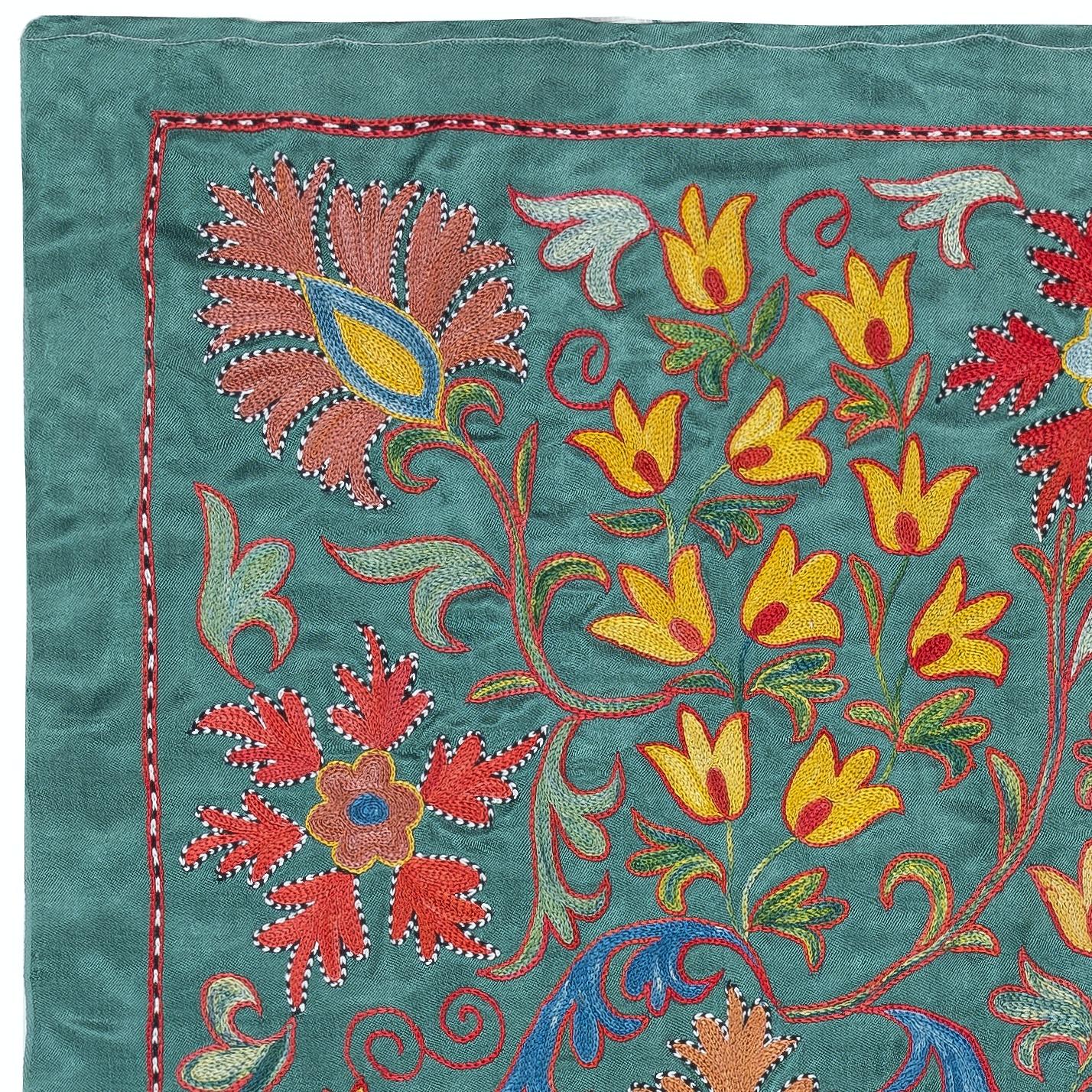Celebrate the rich heritage of Asian craftsmanship with this exquisite 100% silk Suzani textile, meticulously hand-embroidered by skilled artisans. A true work of art, this piece embodies centuries of tradition, featuring intricate floral and