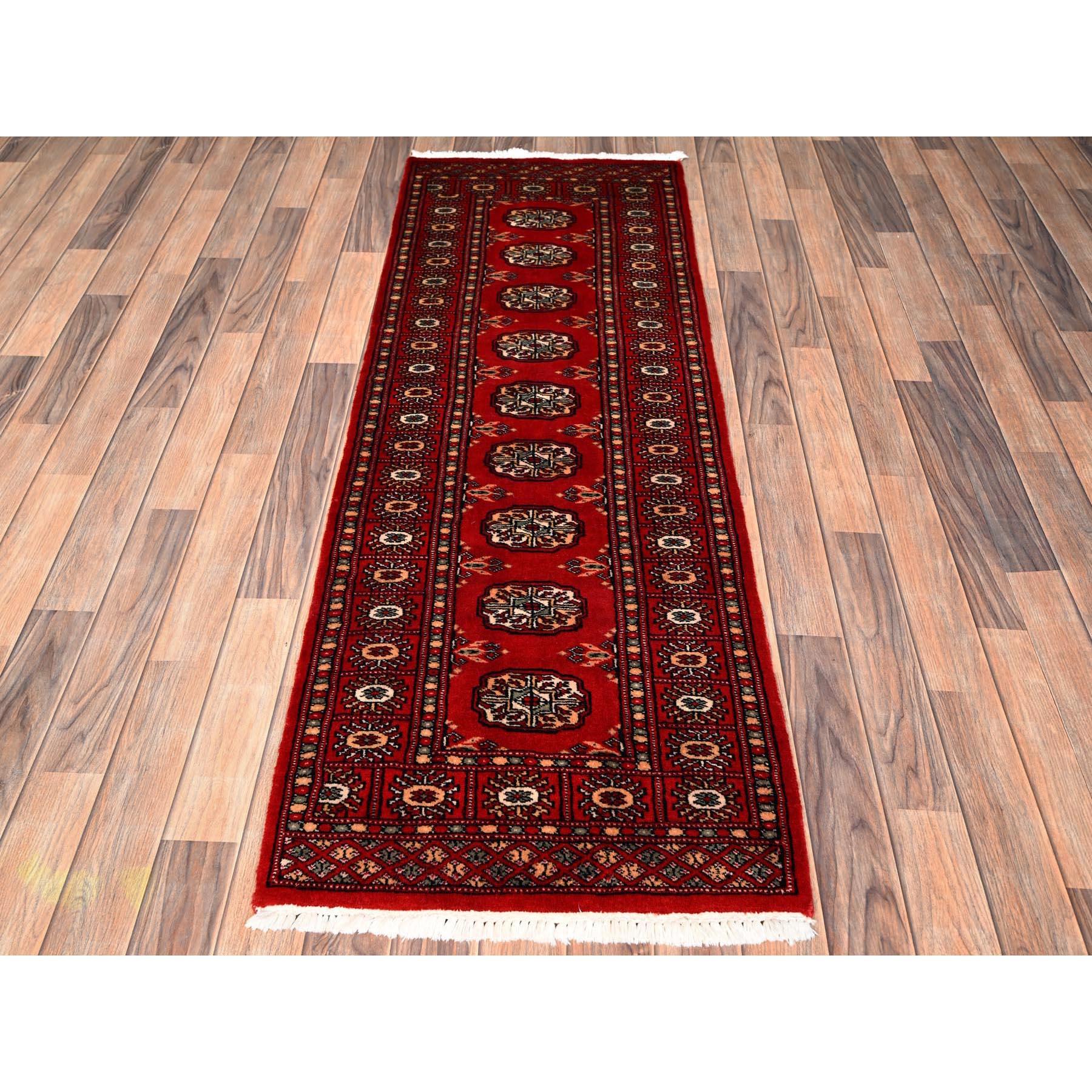 Auburn Red, Princess Bokara with Tribal Medallions, Soft and Velvety Wool, Hand Knotted, Narrow Runner, Oriental Rug
Primary materials: Wool
Latex: No Pile 
height: 0.25 Inches
Style: Traditional
Primary color: Red
Secondary colors: Blue, Peach,