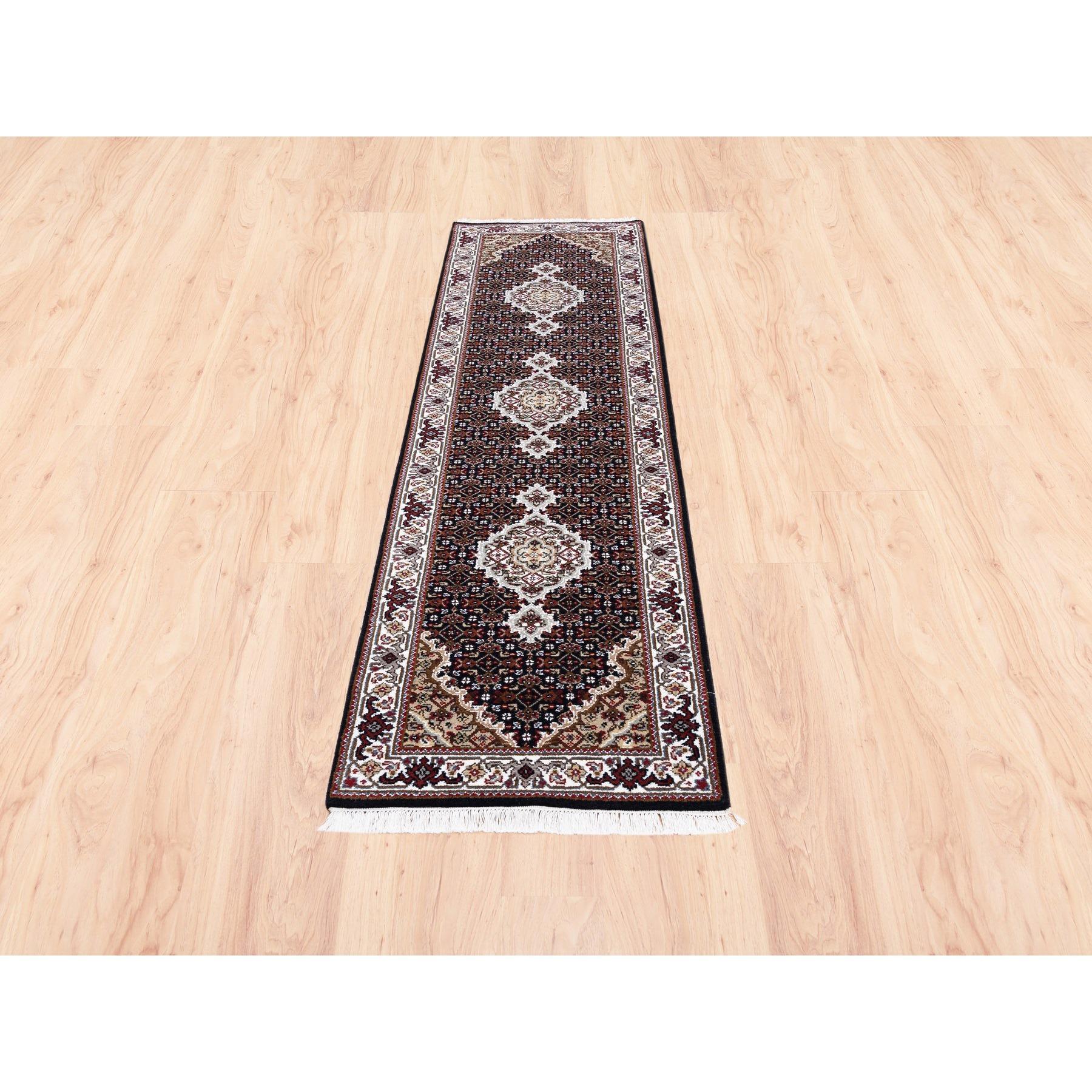 This is a truly genuine one-of-a-kind Tabriz Mahi Fish Medallion Design Black Hand Knotted Wool And Silk Oriental Runner Rug. It has been Knotted for months and months in the centuries-old Persian weaving craftsmanship techniques by expert