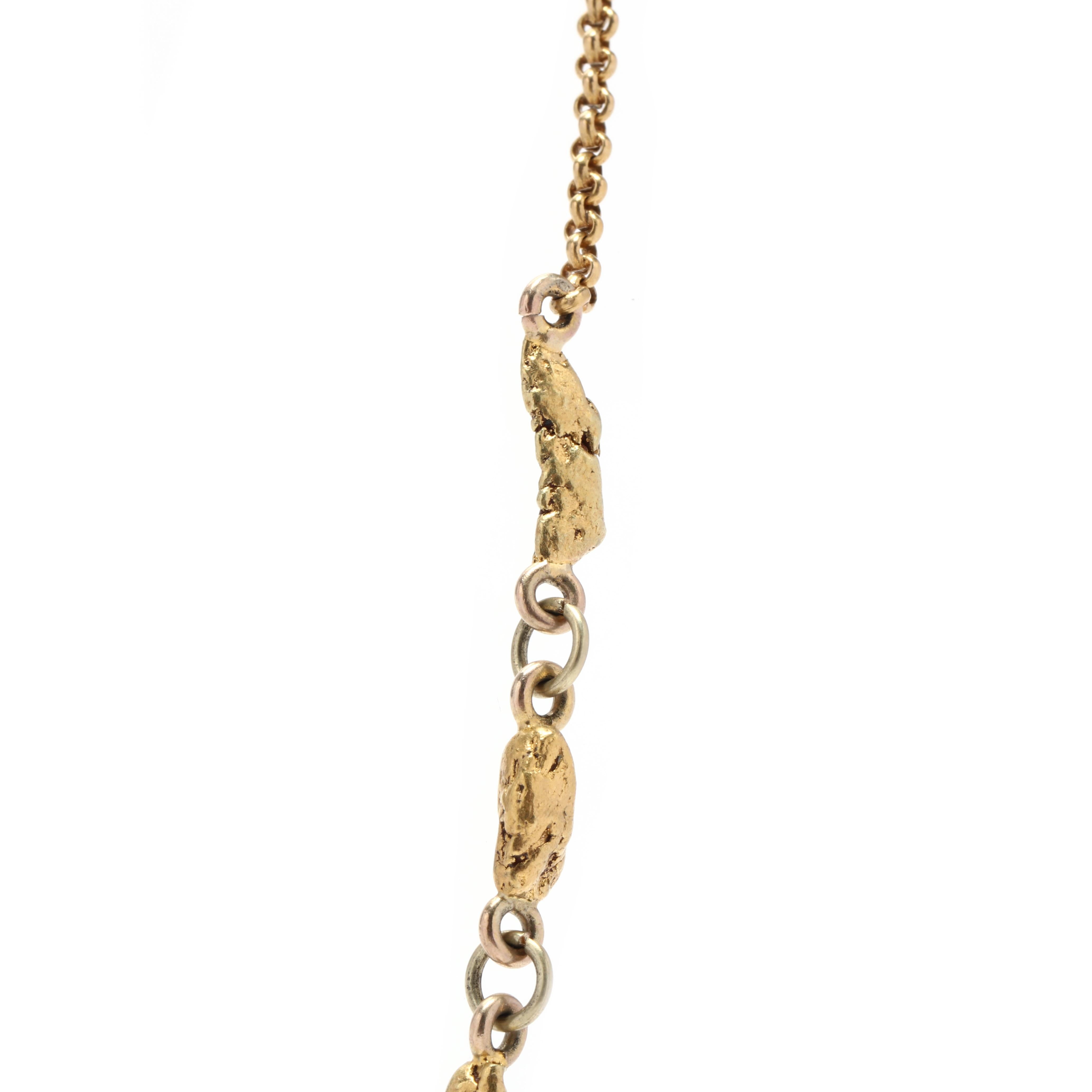 A handmade 22 and 18 karat yellow gold nugget chain. This chain features 22 karat gold nuggets linked together in the center with an 18 karat gold rolo chain on either side with a spring ring clasp.



Length: 15 in.



Width: 4.6 mm



Weight: 7.9