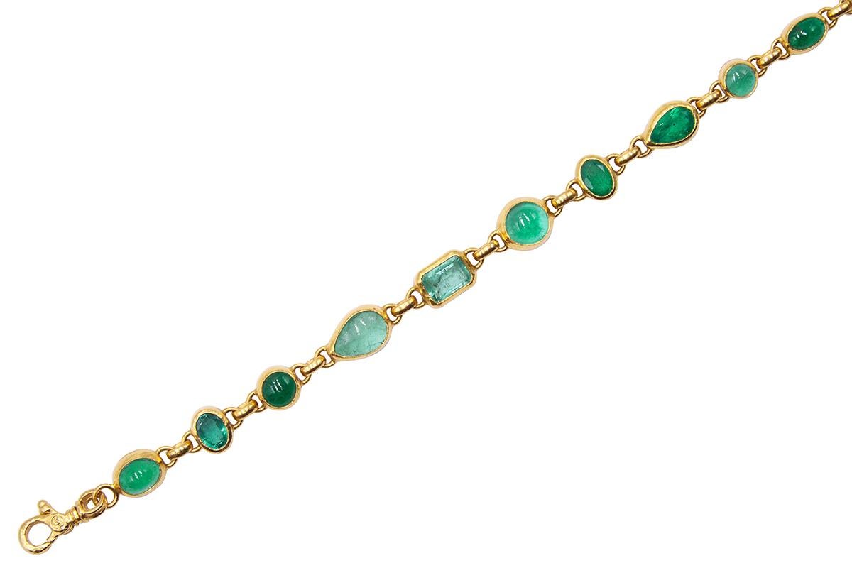 GURHAN all around one-of-a-kind bracelet in 24 Karat hammered yellow gold featuring (11) mixed sized and shaped oval, round, pear, and rectangular faceted and cabochon Emeralds, 18.25cts. Adjustable length from 7.5-8.5
