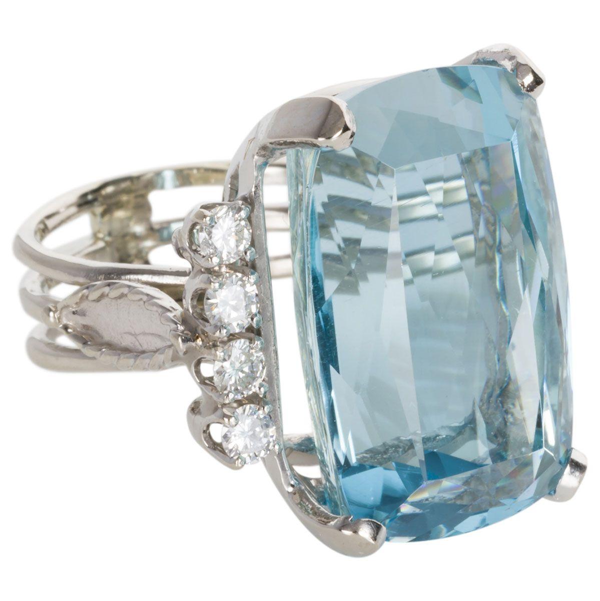 This ring is for the lovers of all things BIG and beautiful. A fabulous cocktail ring with its striking central emerald cut aquamarine with rounded corners - beautifully set in 14k white gold with a sprinkling of white diamonds to add an extra touch
