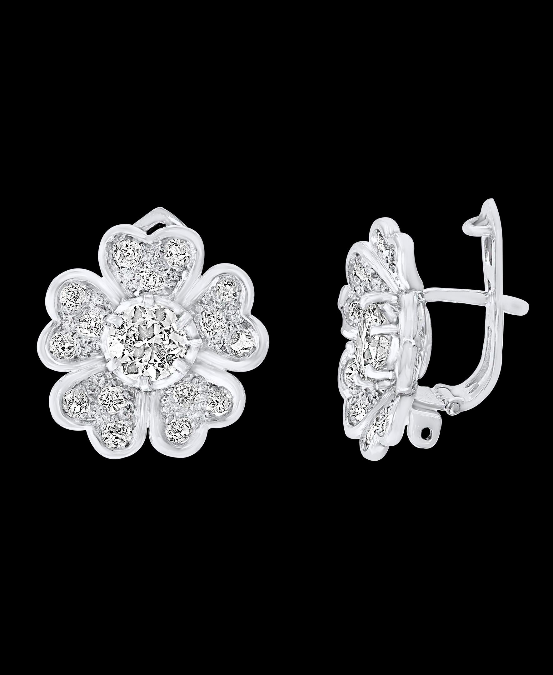 AGI Report # DJ190514001
A fabulous pair of earrings with an enormous amount of look and sparkle!
2.2 carats of F-G color VS clarity diamonds set in solid platinum  with omega backs.
Cluster earrings, centering 0.7 carat round solitaire  diamond 