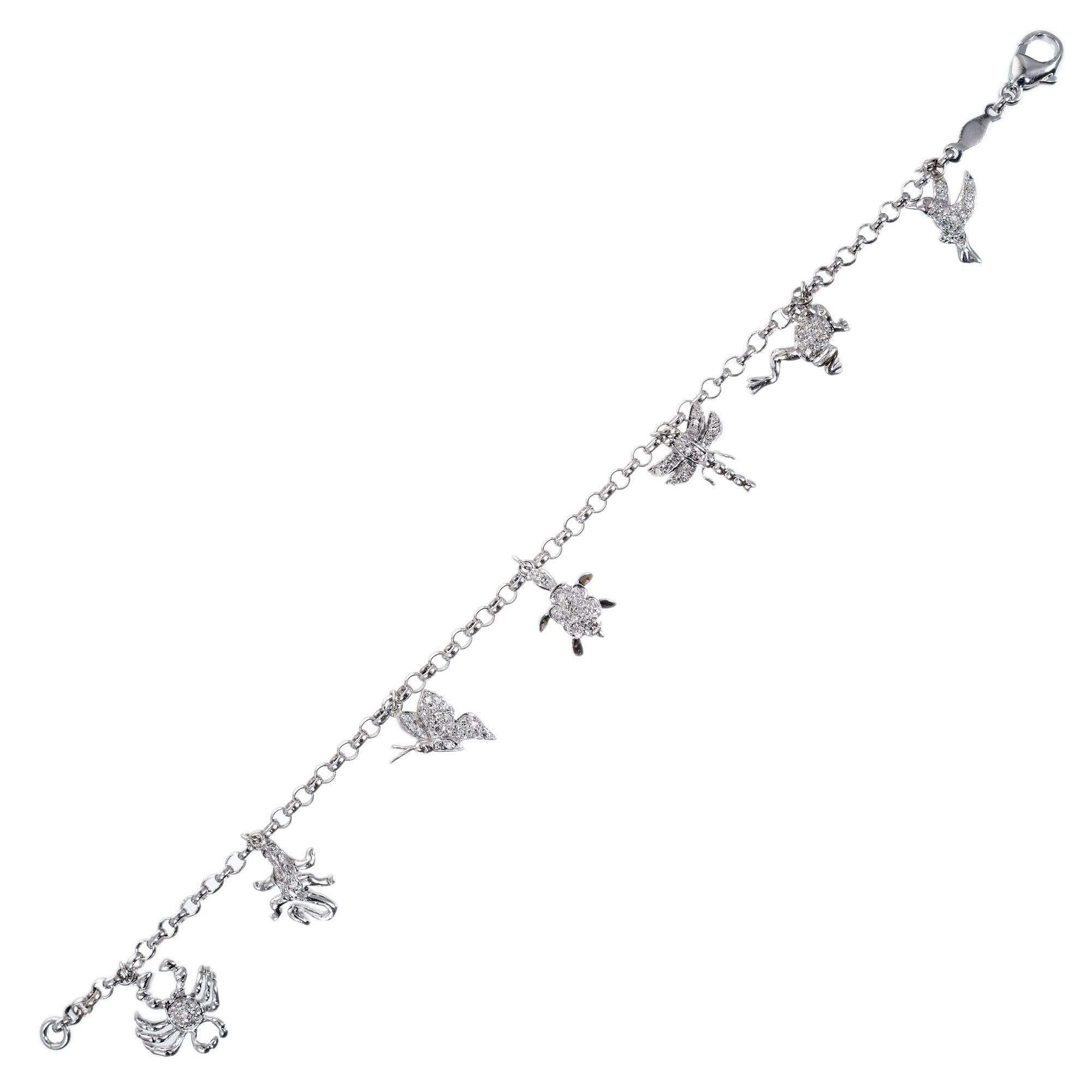 Vintage mid-century 1950's 14k white gold charm bracelet with 7 Diamond studded charms. Crab, Lizard, Butterfly, Turtle, Dragonfly, Frog & Hummingbird. 7 inches in length

87 single cut Diamonds, approx. total weight .22cts, H – I, SI – I
14k white