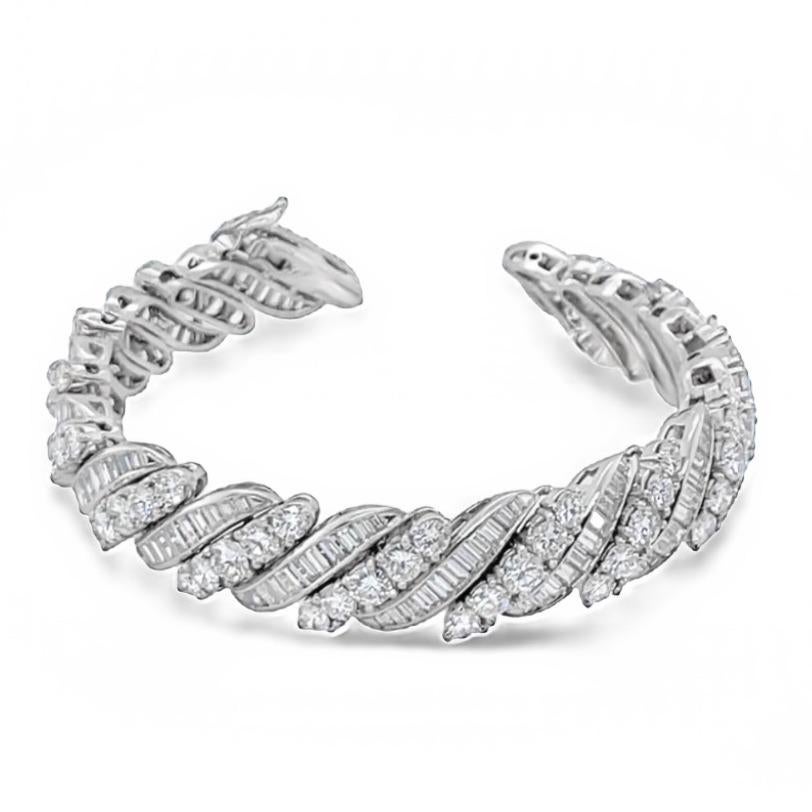 This tennis link diamond bracelet has a beautiful design inspired by the lines on a barber-pole. The bracelet is made in platinum, has 224 baguette and round diamonds and weighs 22 carats in total.  The baguette diamonds are channel set and the