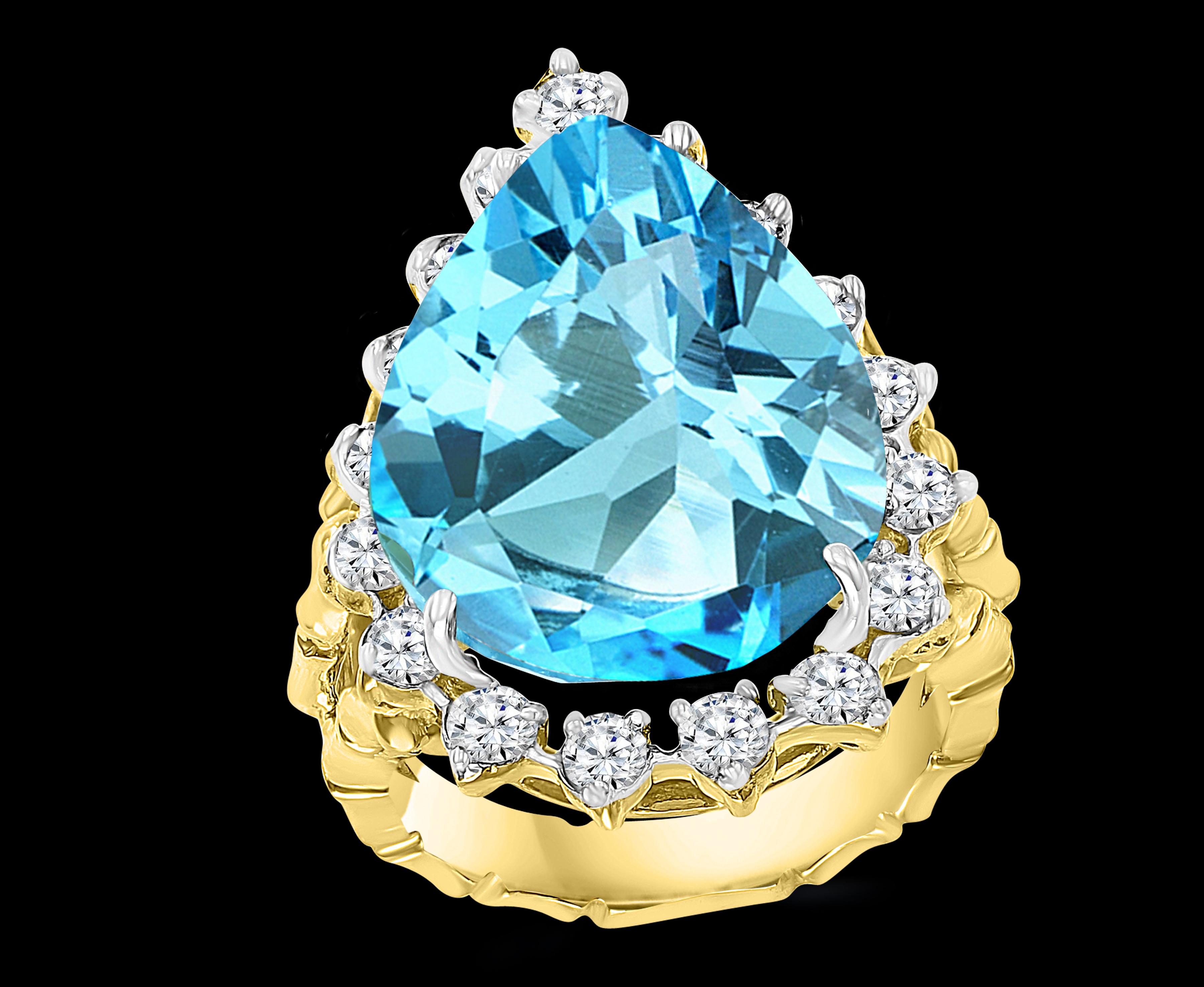 Approximately 22 Carat Natural Blue Topaz & Diamond Cocktail Ring 18 Karat Yellow Gold, Estate
A classic, Cocktail ring 
Huge 22 Carat of very clean no inclusion  Blue Topaz Pearl shape , full of luster and shine with dark color
Approximately 1.65 