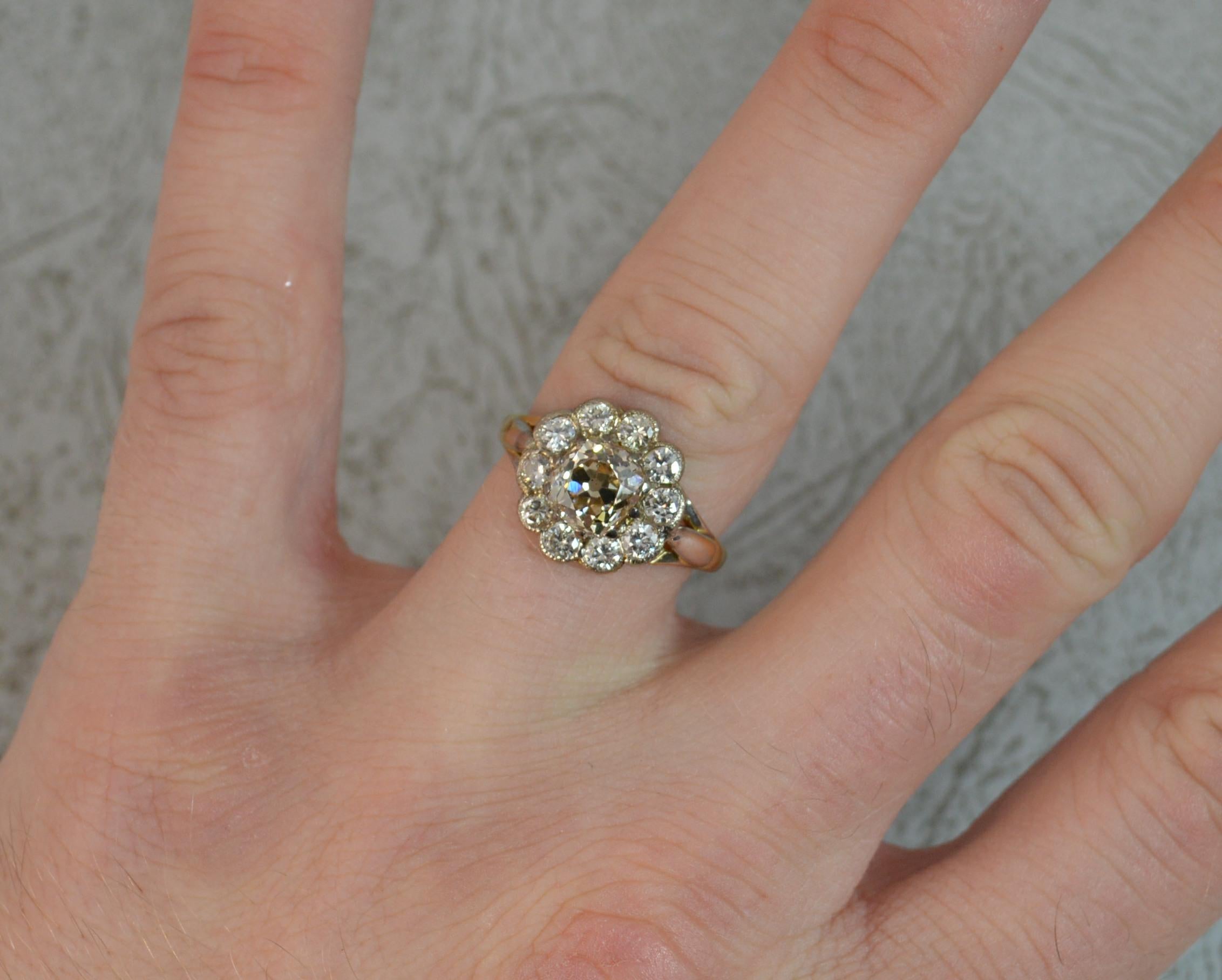 A stunning late Victorian diamond cluster ring.

Designed with a natural old European cut diamond in multi claw setting to centre. Weighed as 1.52 carats. Clean, si clarity, light champagne natural colour. 6.9mm diameter.

Surrounding are ten