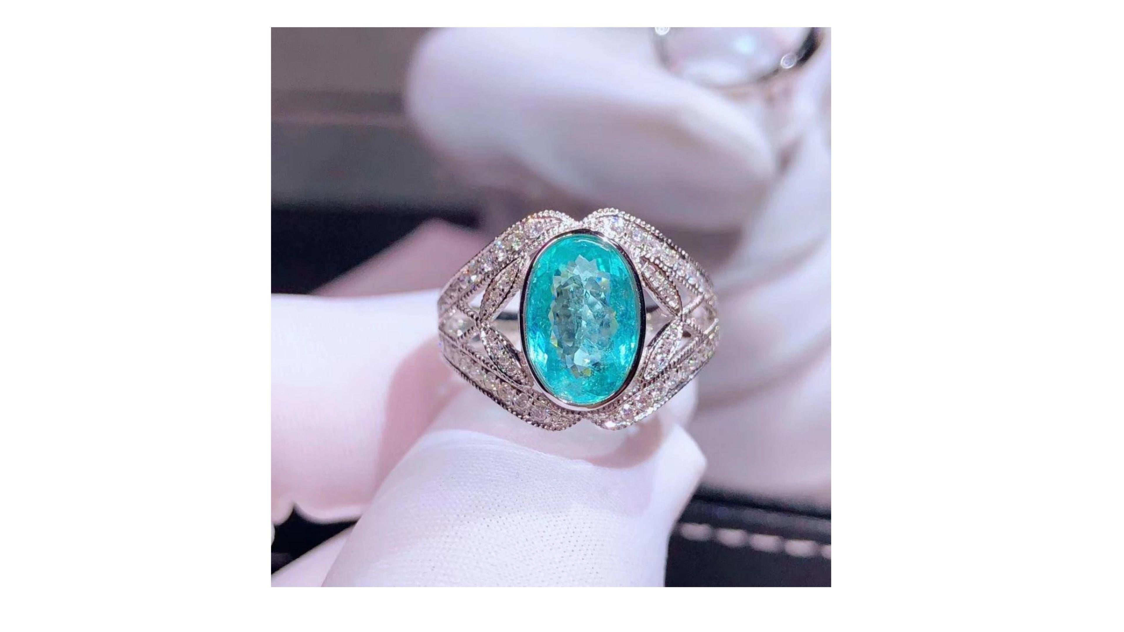 

This is rare Pariba Tourmaline Ring at 2.22ct with 36 diamonds set in 18k white gold

The story of this neon-bright tourmaline’s discovery is as intriguing as the stone itself. Hidden for many years beneath hills in the north-eastern Brazilian