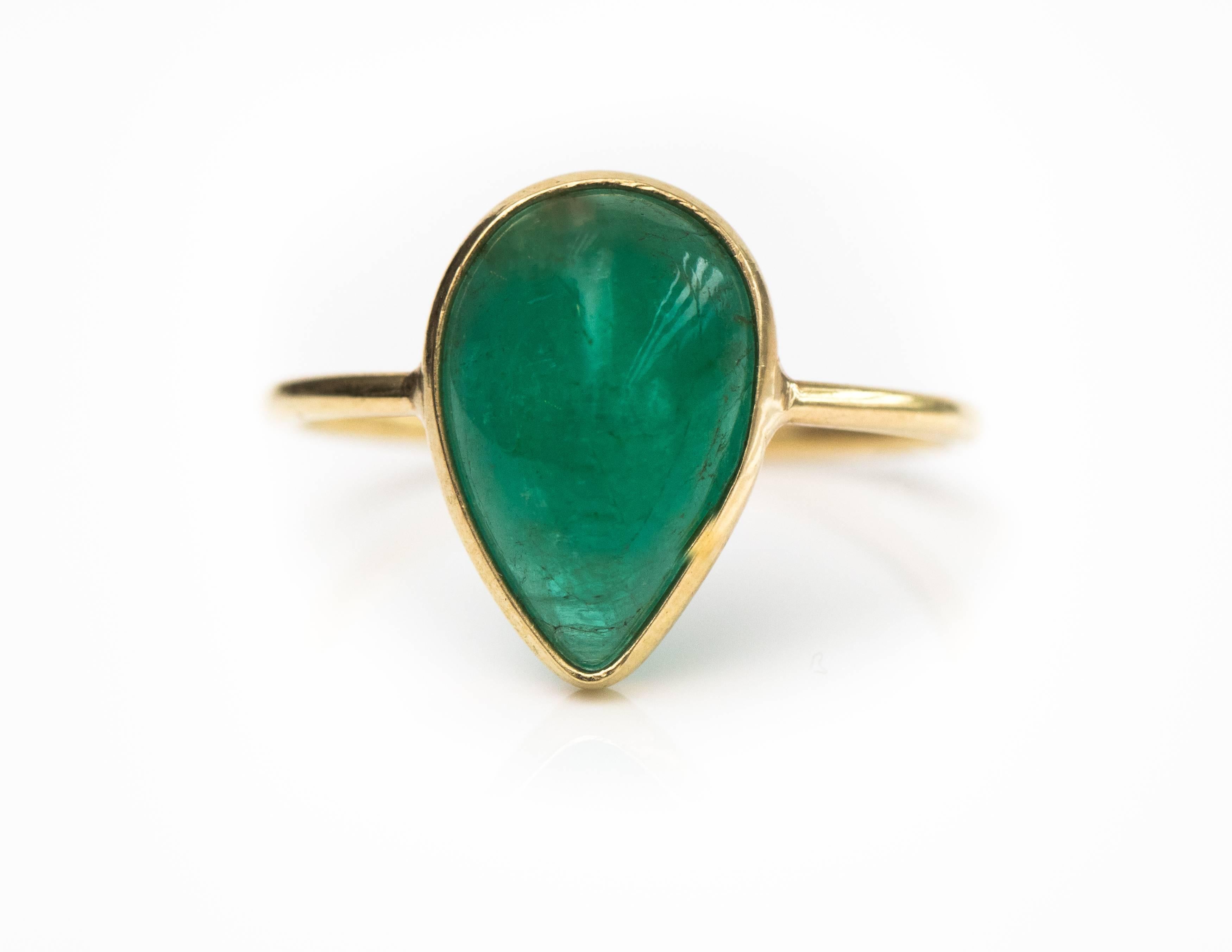 2.2 Carat Pear cut South American Emerald Ring - 18 Karat Yellow Gold, Emerald

Features a Pear cut Emerald cabochon bezel set in 18 Karat Yellow Gold. This South American Emerald has a deep, rich green color. The unusually shaped Cabochon has a
