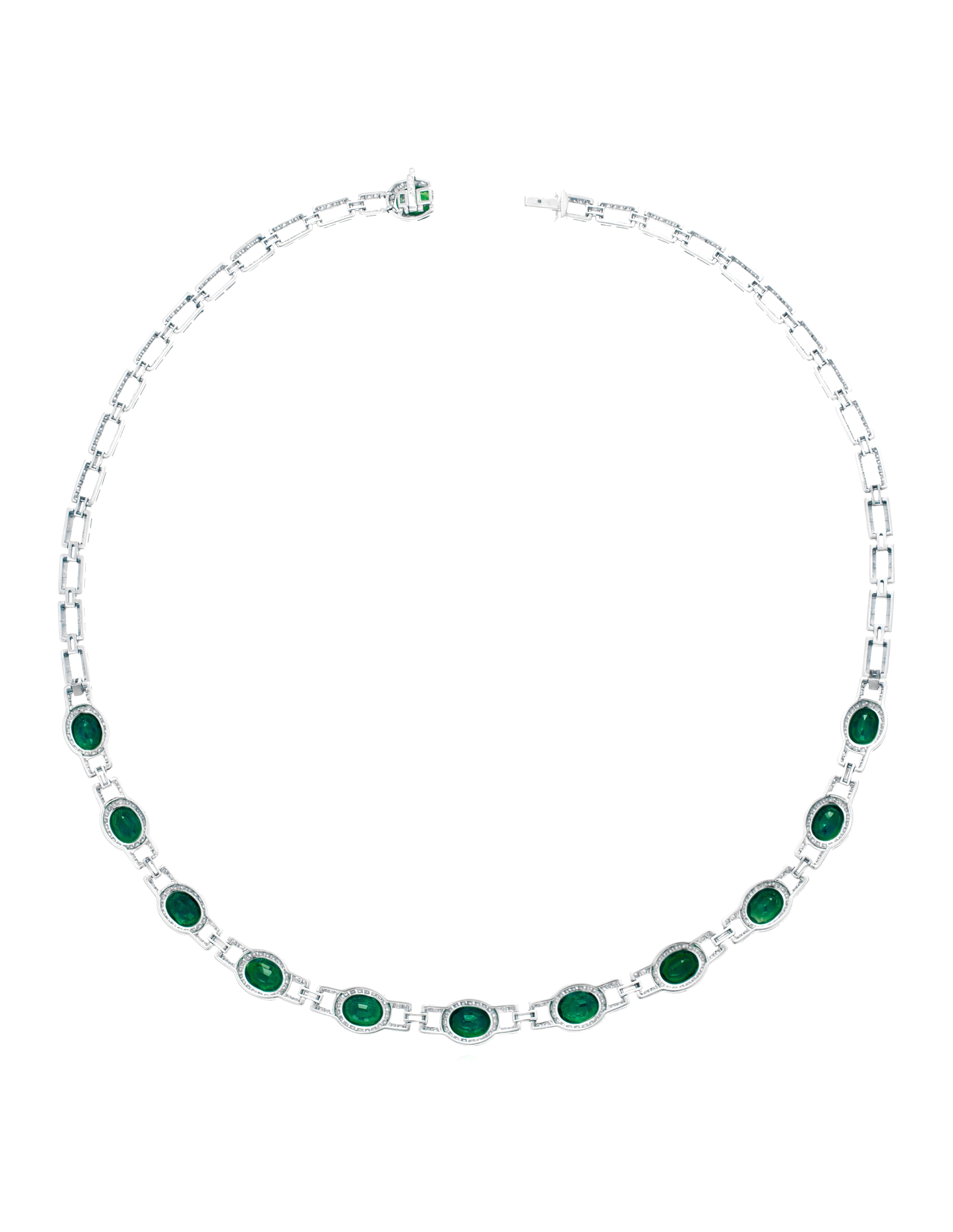 This exquisite piece features a front design of oval-cut emeralds set within diamond frames, connected to a back chain of diamond-set links. 

The metal is platinum. The diamonds include 676 round diamonds with a total weight of approximately 3.25 -