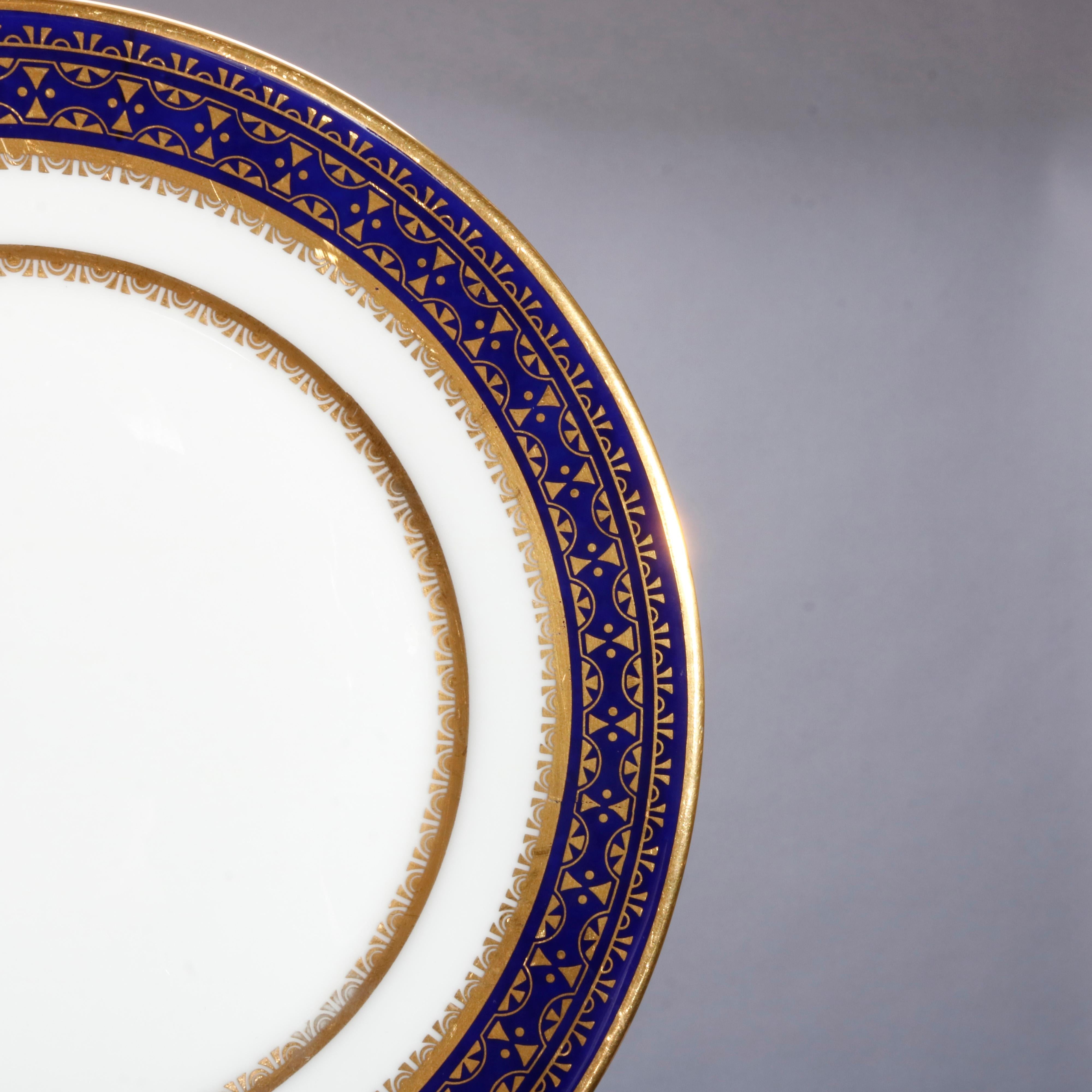 A set of 22 English Oxford bone China salad and bread plates offer cobalt blue bordering with gold gilt highlights, en verso maker mark as photographed, 20th century

Measures: salad 8